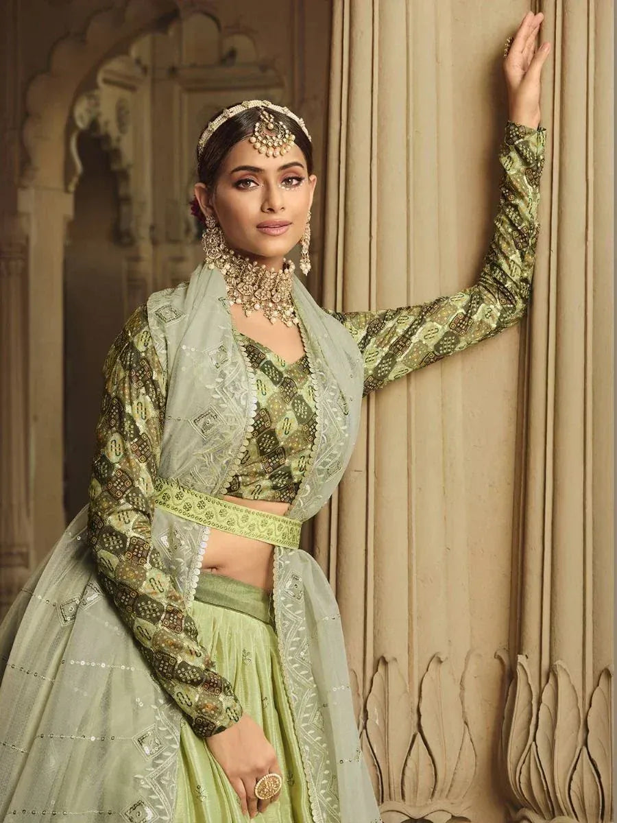 Elegant green embroidered lehenga choli with sheer dupatta, perfect for Indian ethnic wear occasions.