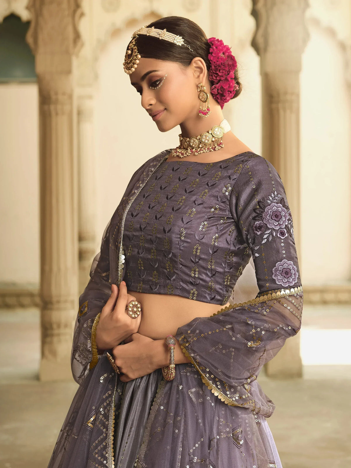 Elegant purple lehenga choli with floral embroidery and gold detailing, perfect for Indian ethnic wear.