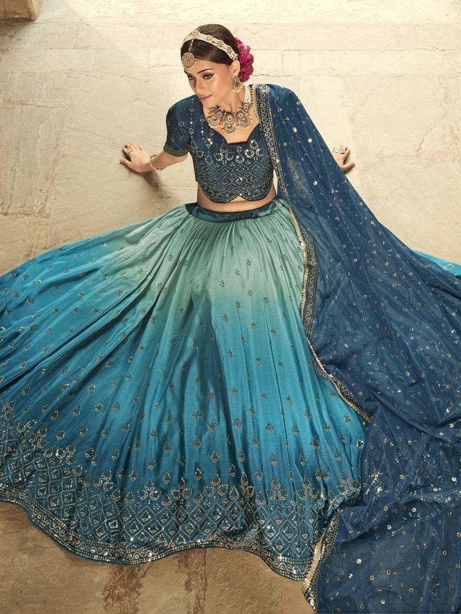 Blue ombre lehenga choli with gold embroidery, perfect for Indian weddings and festive occasions.