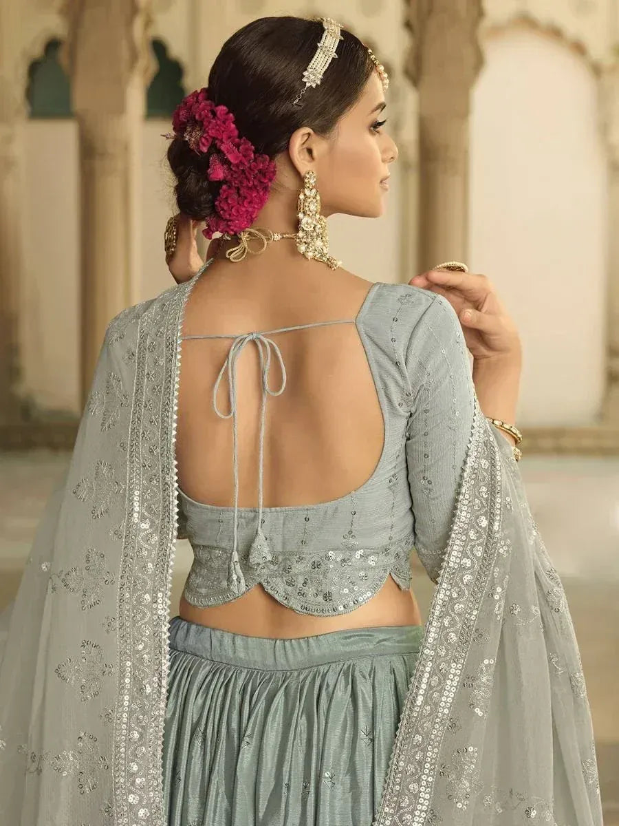 Elegant grey lehenga choli with back tie, sequin dupatta, and floral hair accessory for Indian ethnic wear