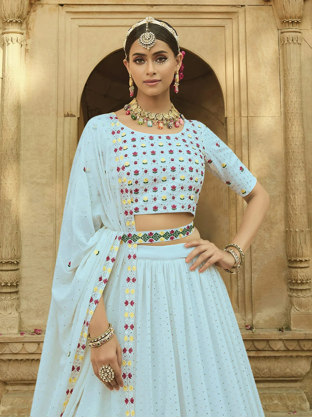 Light blue embroidered lehenga choli with floral motifs, perfect for Indian ethnic wear occasions