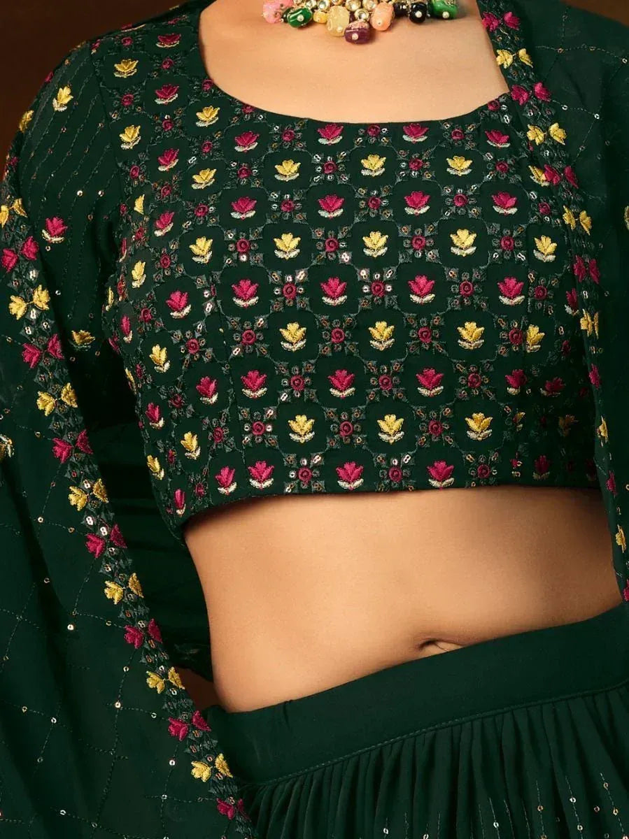 Green embroidered crop top with floral motifs, paired with matching skirt for Indian ethnic wear