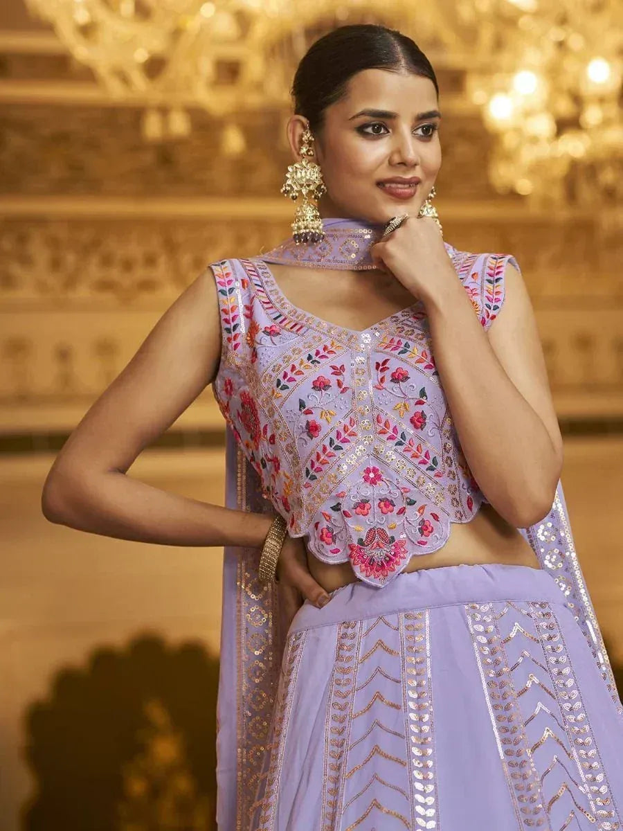 Lavender embroidered lehenga choli with floral motifs and gold detailing, perfect for Indian ethnic occasions.