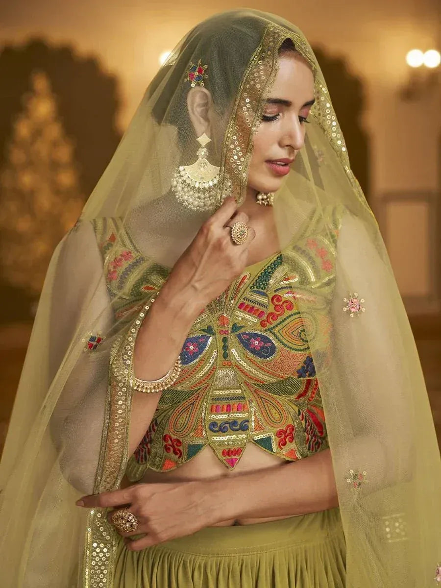 Olive green embroidered lehenga choli with sheer dupatta, perfect for Indian weddings and festive occasions.