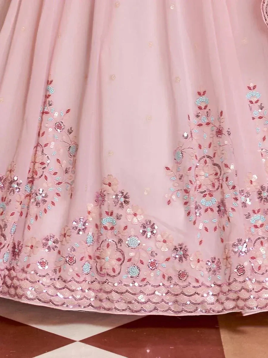 Pink lehenga with floral sequin embroidery and scalloped hem, ideal for Indian ethnic wear occasions.
