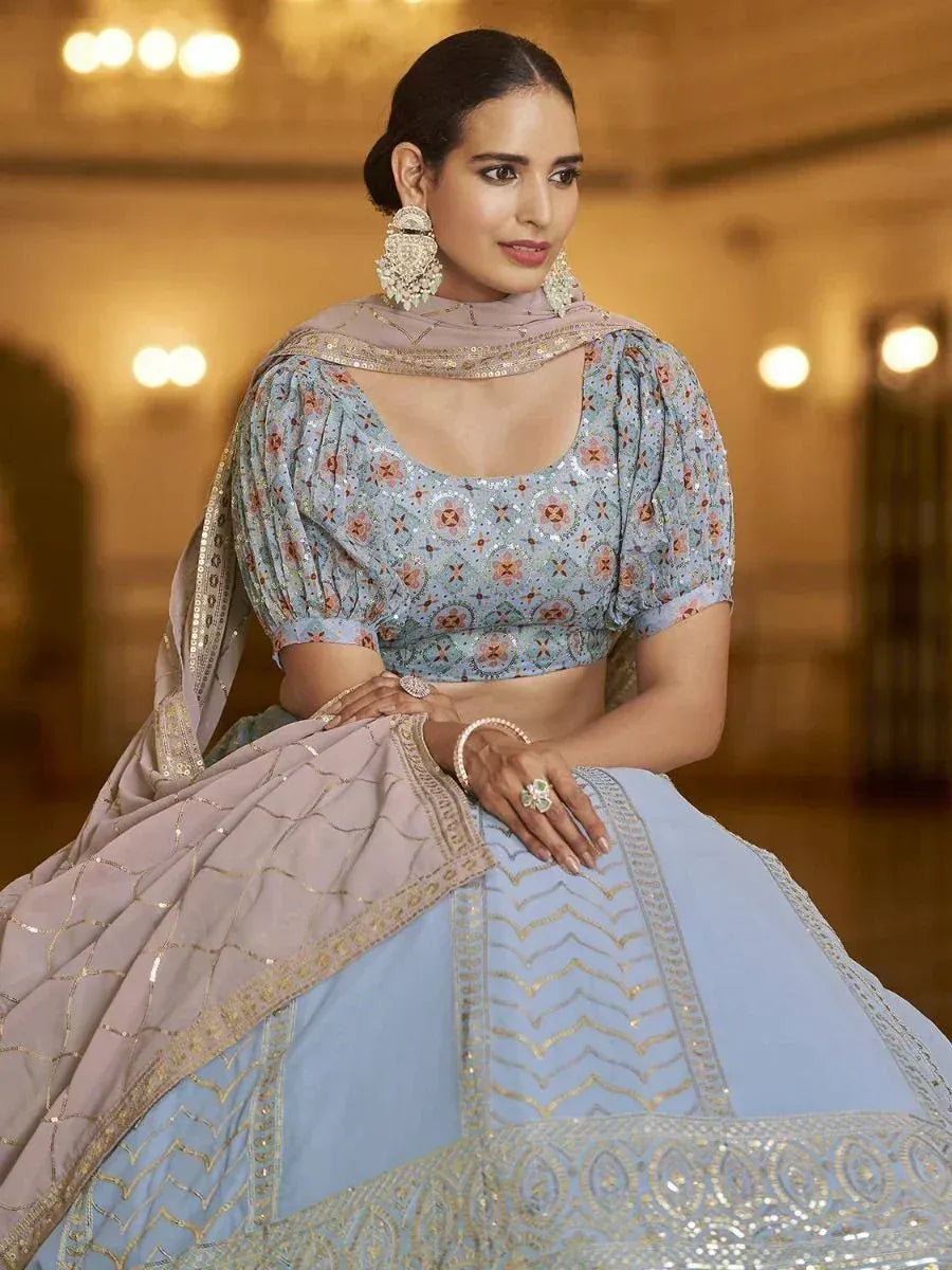 Light blue designer lehenga choli with floral embroidery and gold detailing, paired with matching dupatta