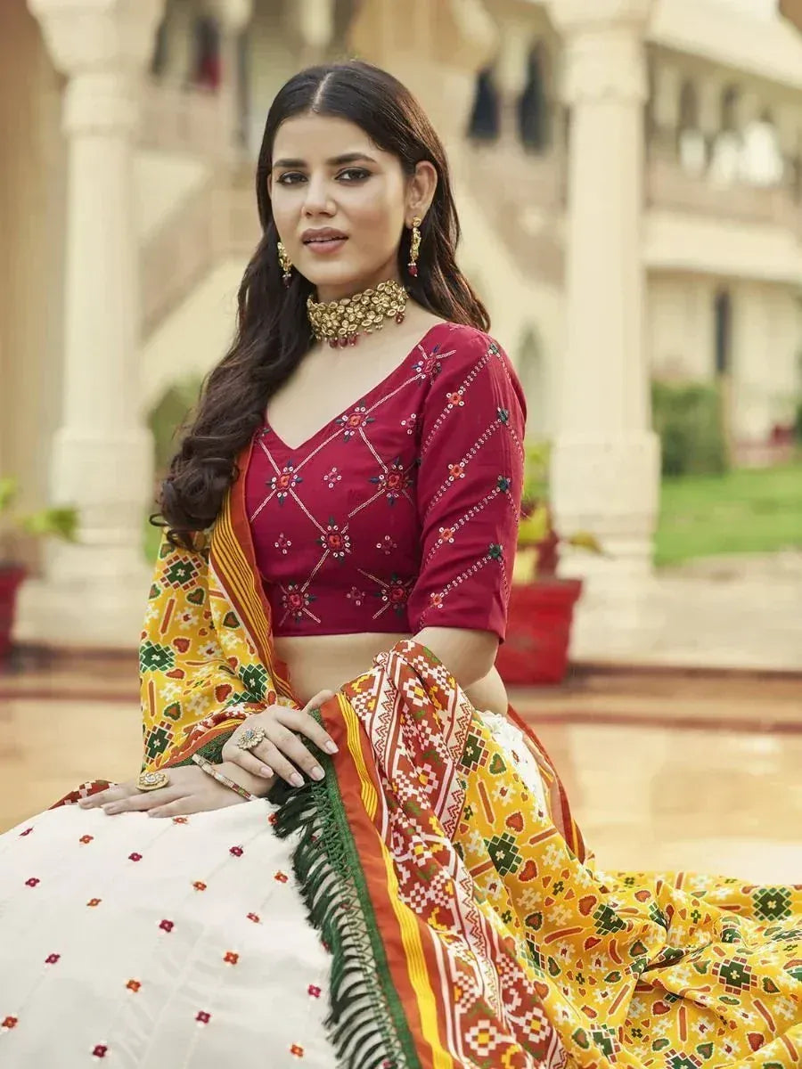 Woman in red embroidered blouse and colorful printed lehenga choli, traditional Indian ethnic wear