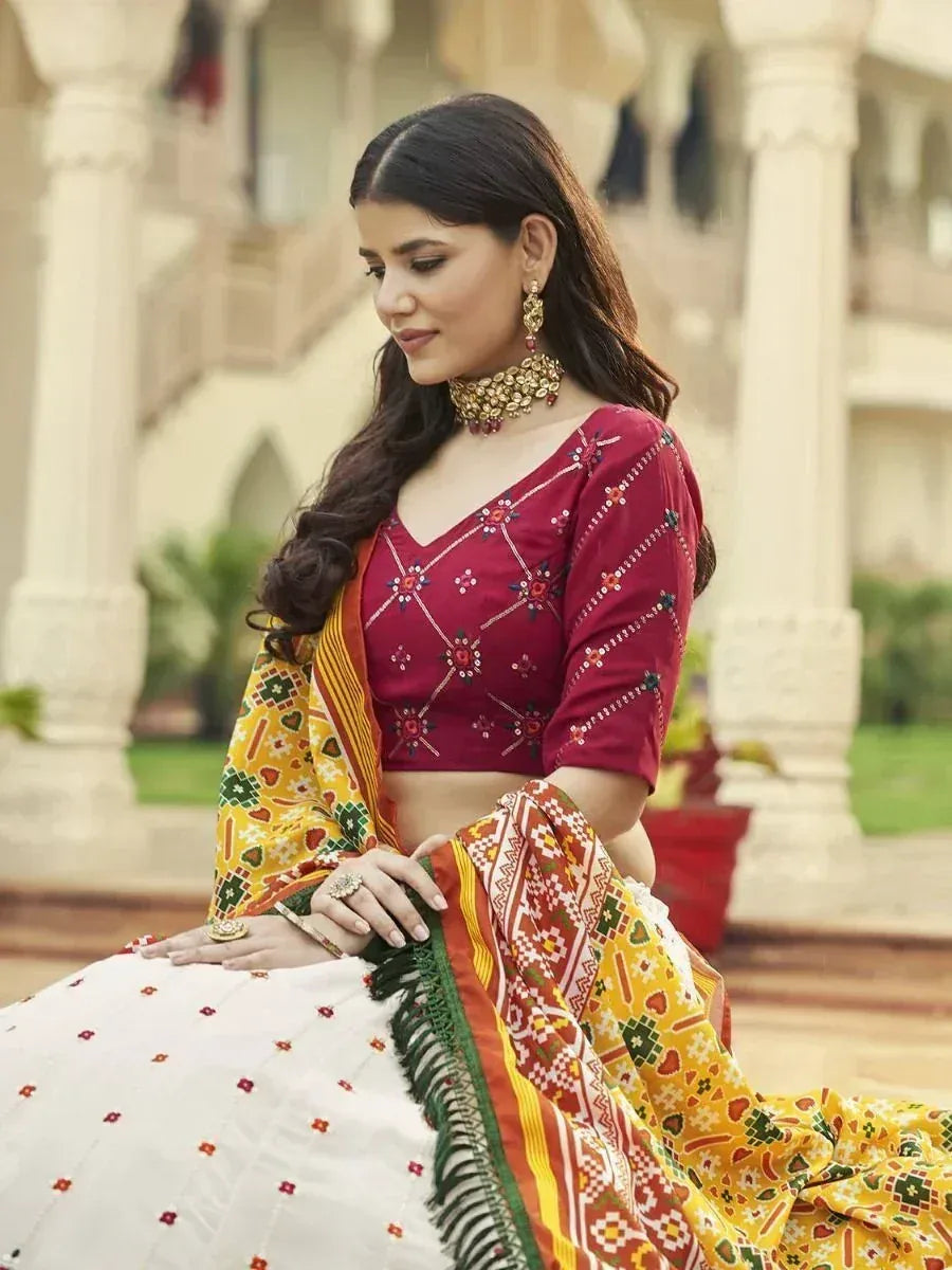 Woman in maroon embroidered blouse with colorful printed dupatta, traditional Indian ethnic wear