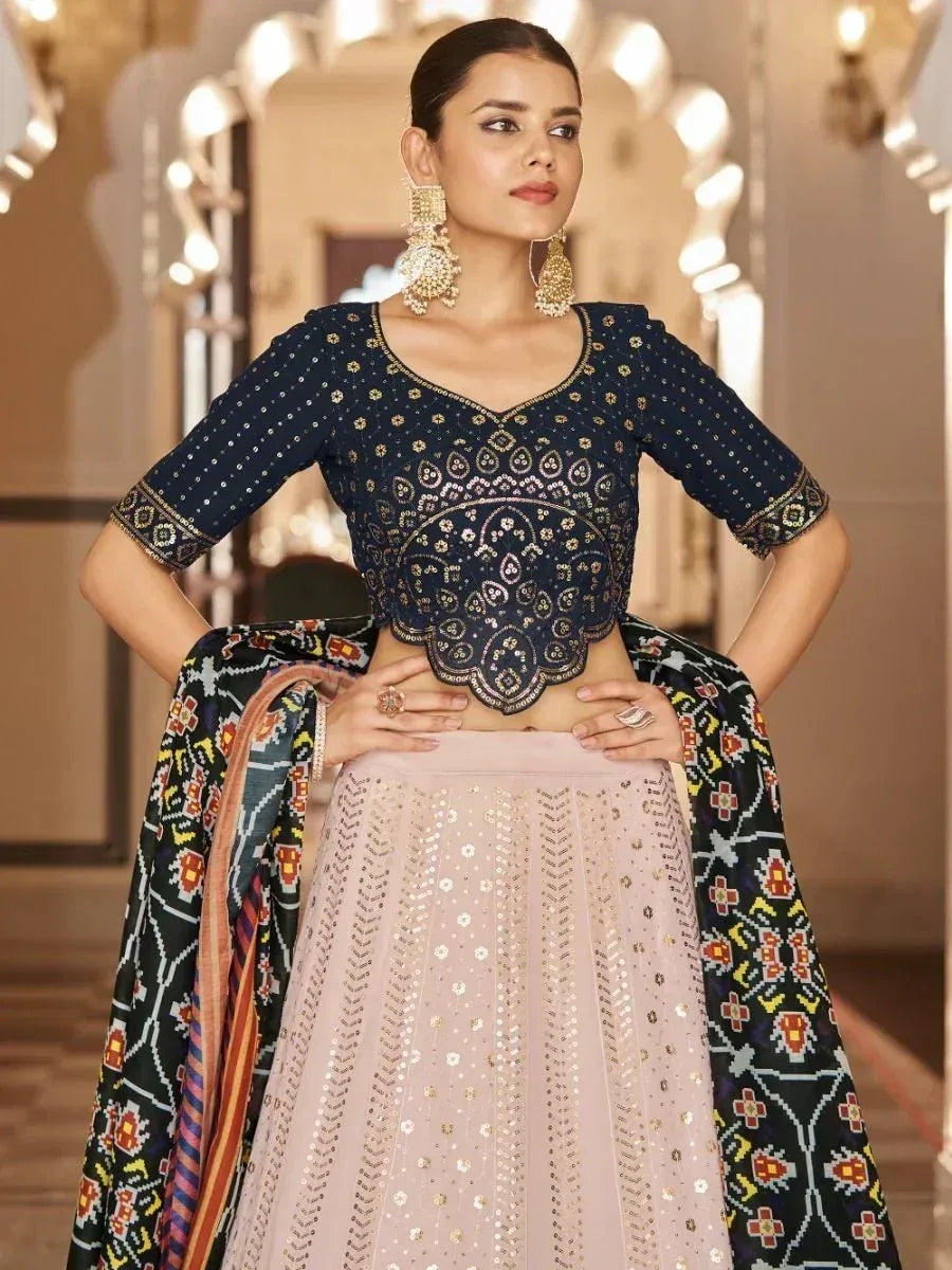 Elegant navy blue embroidered blouse with scalloped hem paired with blush pink lehenga and printed dupatta