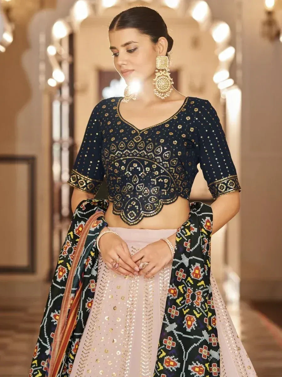 Elegant navy blue embroidered crop top with pink lehenga and patterned dupatta, perfect for Indian ethnic wear occasions.