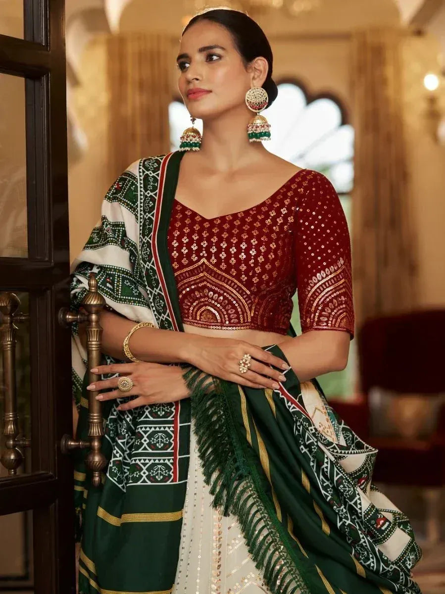 Woman in red embroidered blouse with green and white patterned saree, traditional Indian ethnic wear