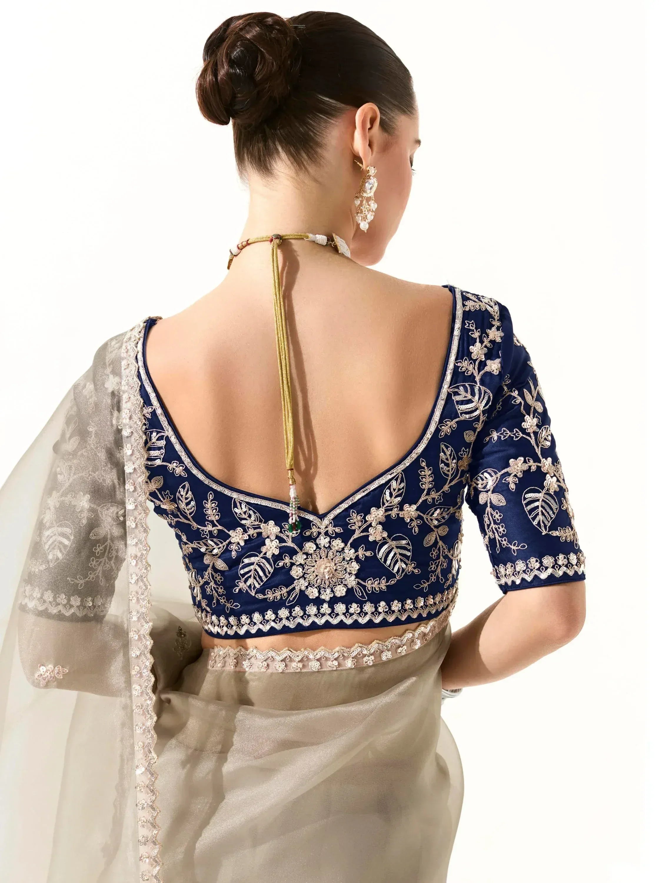 Navy blue embroidered blouse with back tie, paired with sheer saree, perfect for Indian ethnic wear