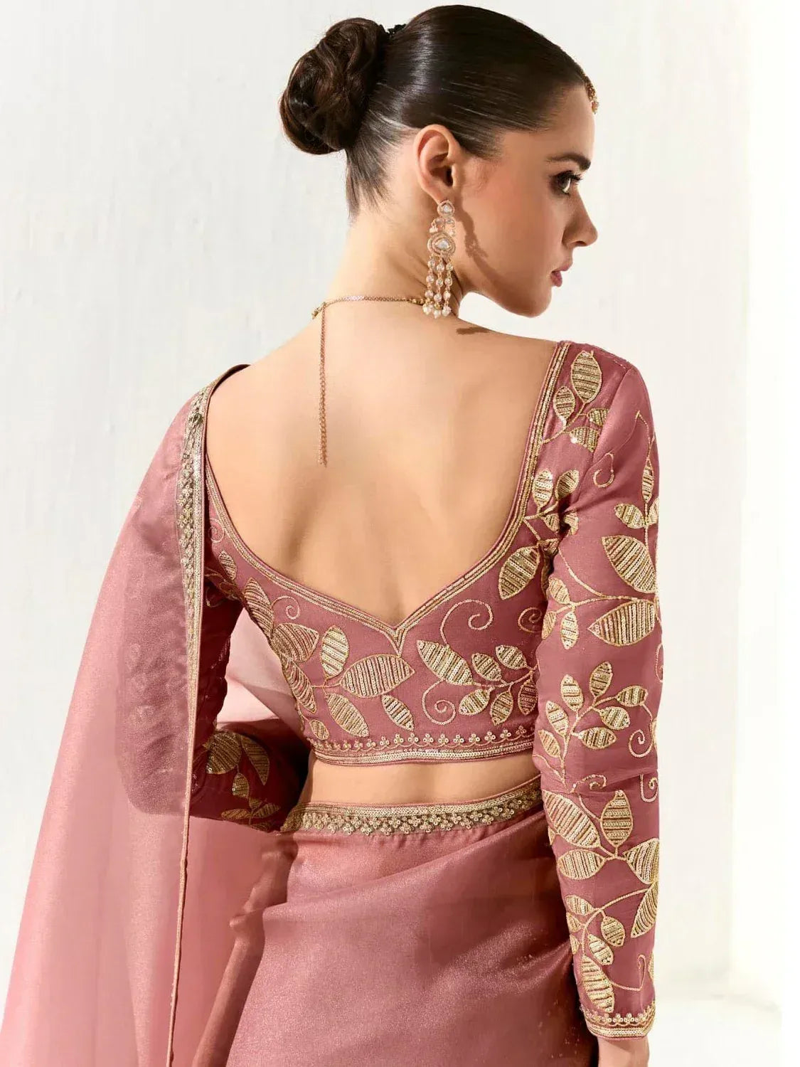 Dusty pink designer lehenga choli with gold leaf embroidery, backless blouse, and sheer dupatta