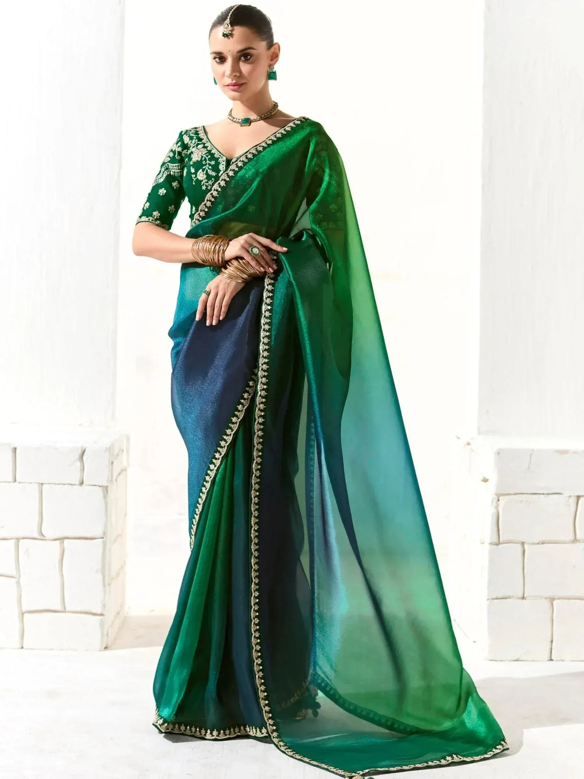 Emerald green and navy blue designer saree with gold embroidery, perfect for Indian ethnic wear occasions.