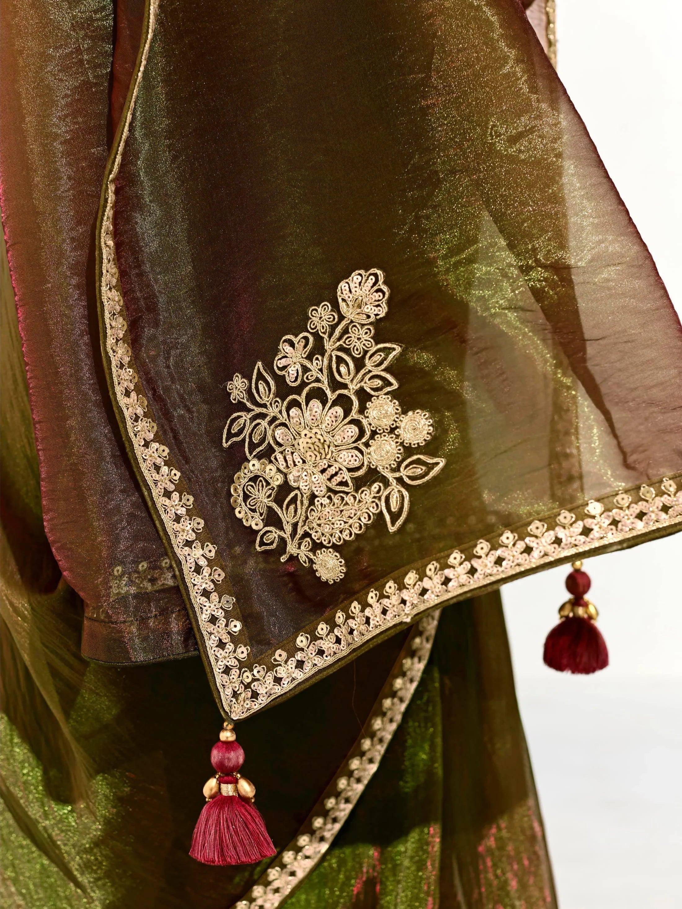 Elegant Indian ethnic saree with gold floral embroidery, sequin border, and maroon tassels