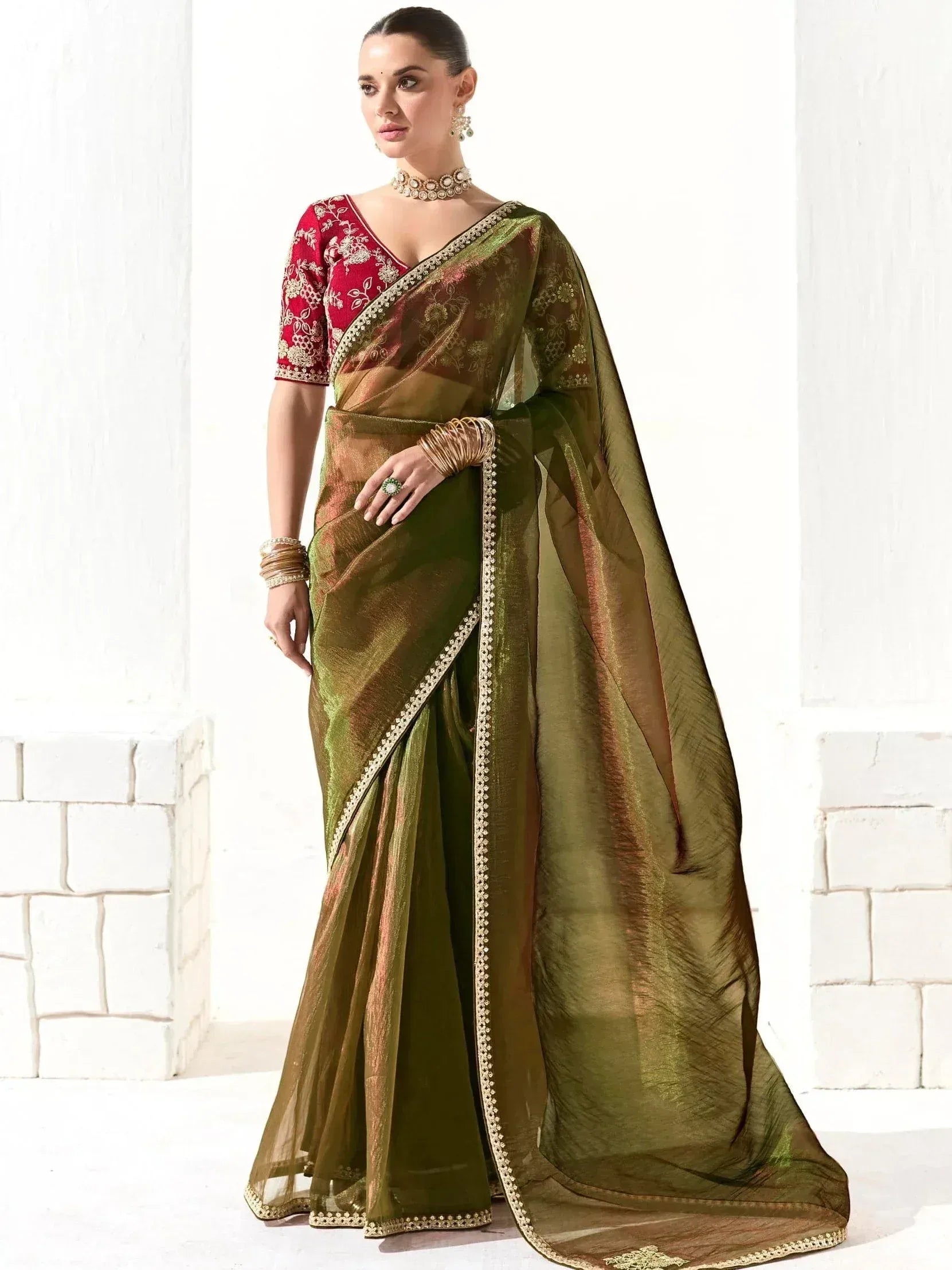 Olive green designer saree with gold embroidery and red blouse, perfect for Indian ethnic wear occasions.