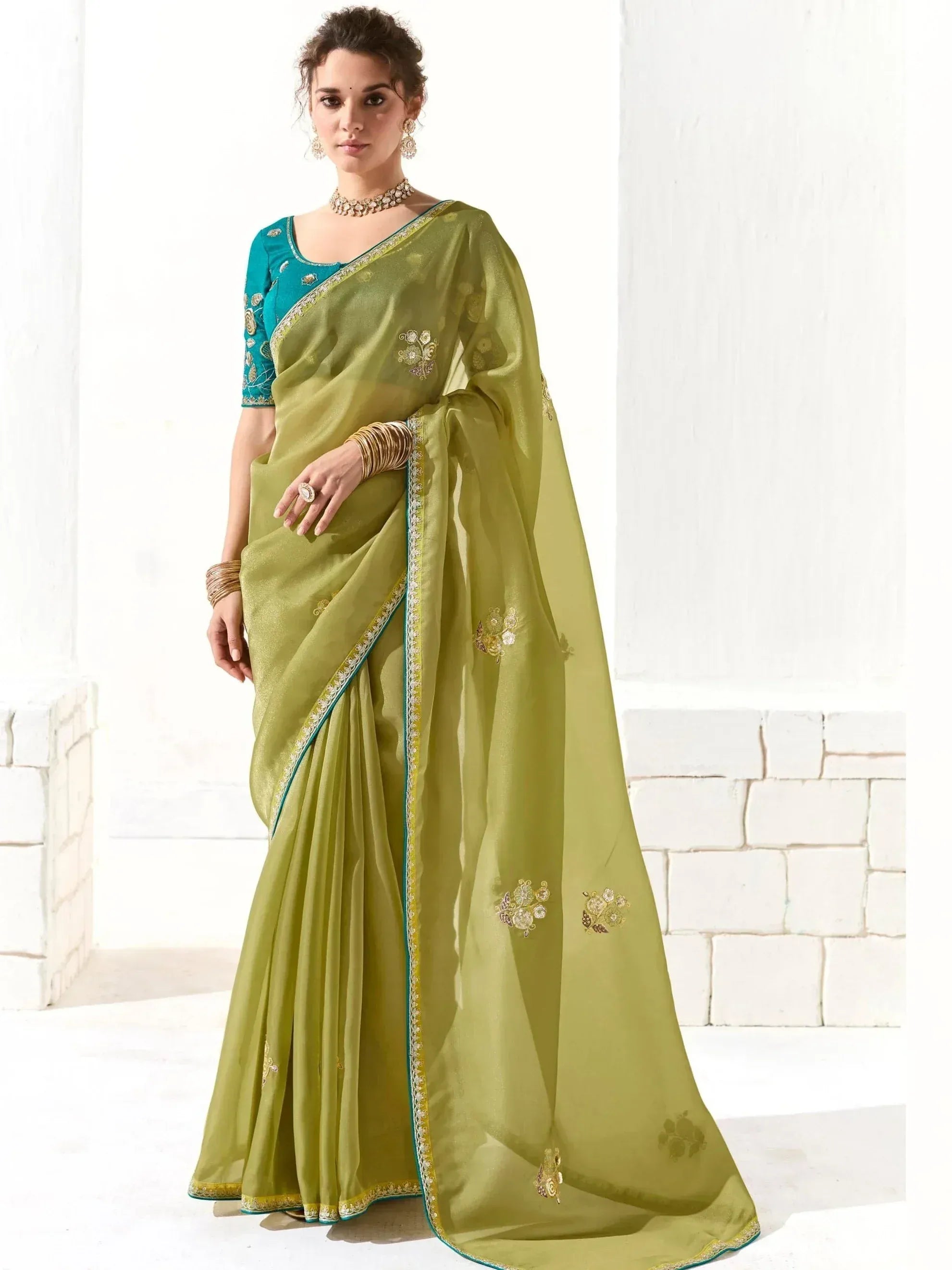 Olive green embroidered saree with teal blouse, perfect for Indian ethnic wear and festive occasions.