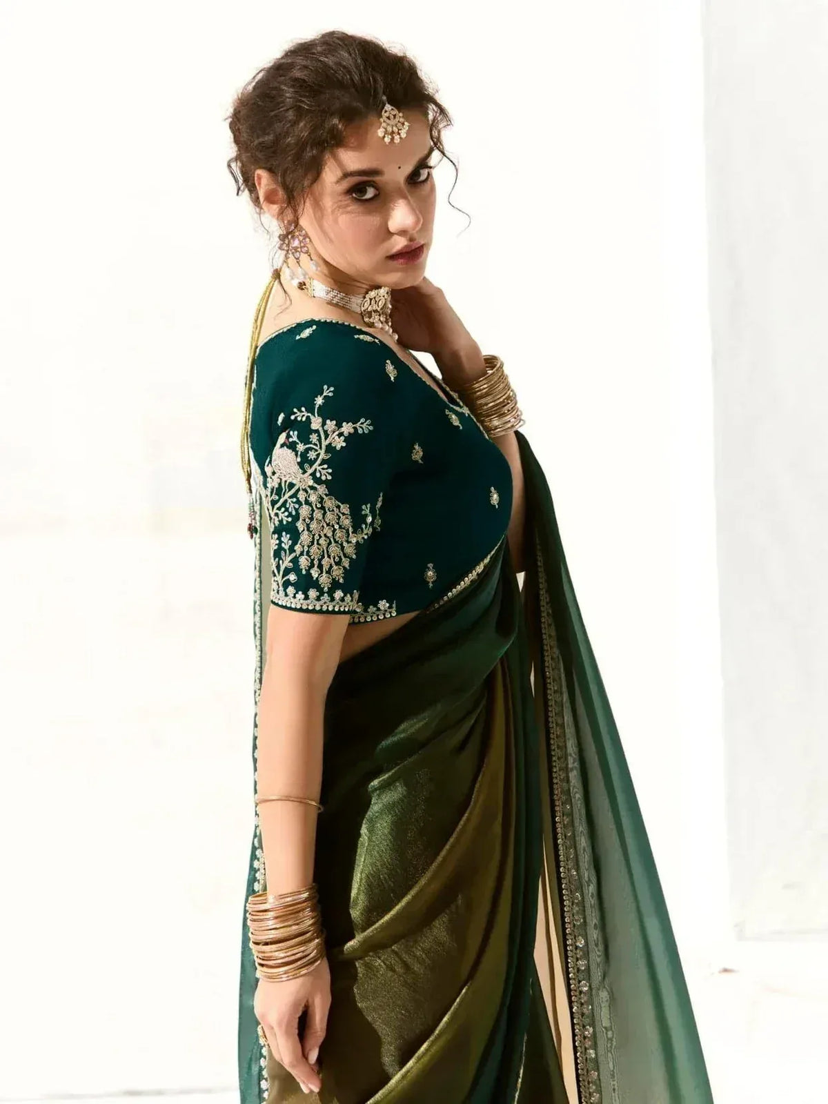 Emerald green saree with gold embroidery, perfect for Indian ethnic wear and festive occasions.