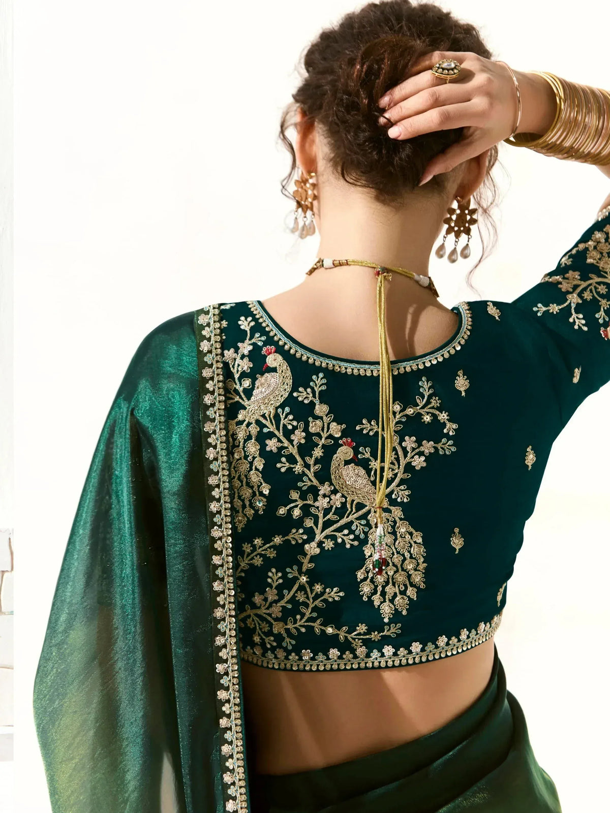 Emerald green embroidered blouse with peacock design, perfect for Indian ethnic wear and festive occasions.