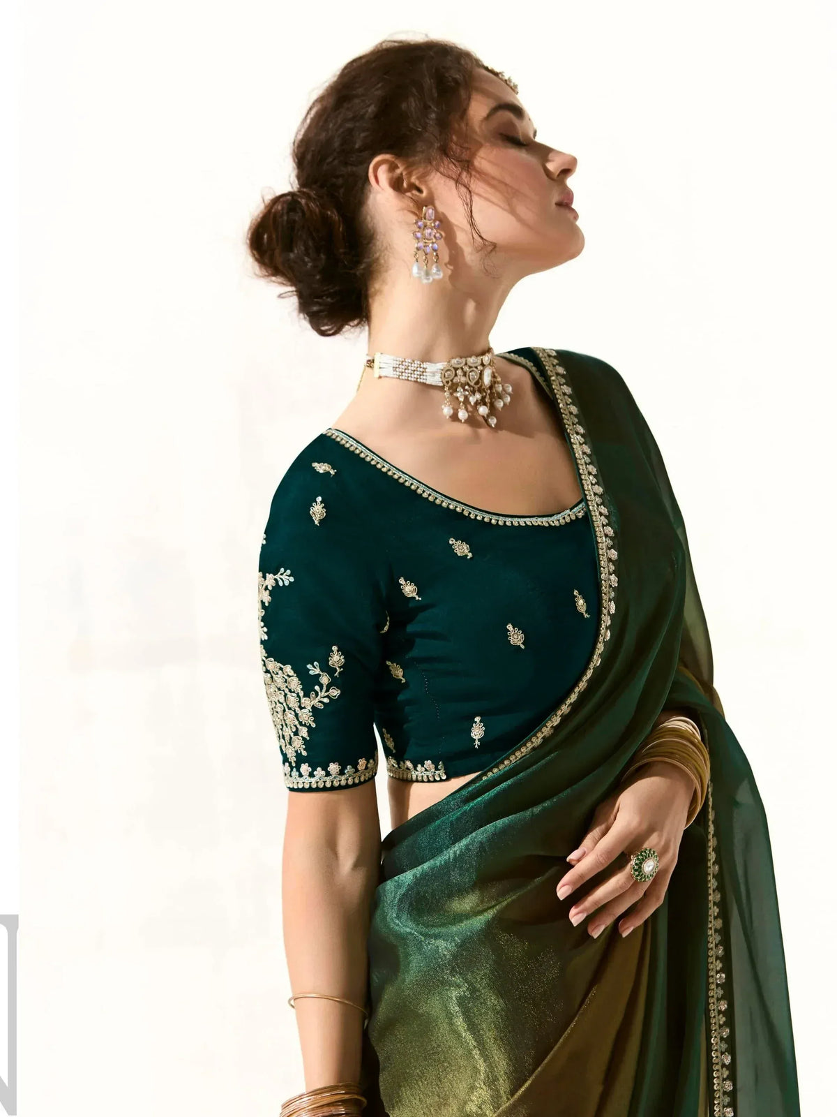 Elegant green embroidered saree with matching blouse, perfect for Indian ethnic wear occasions.