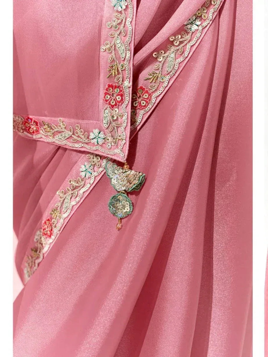 Pink ethnic gown with floral embroidery and sequin tassels, perfect for Indian festive wear