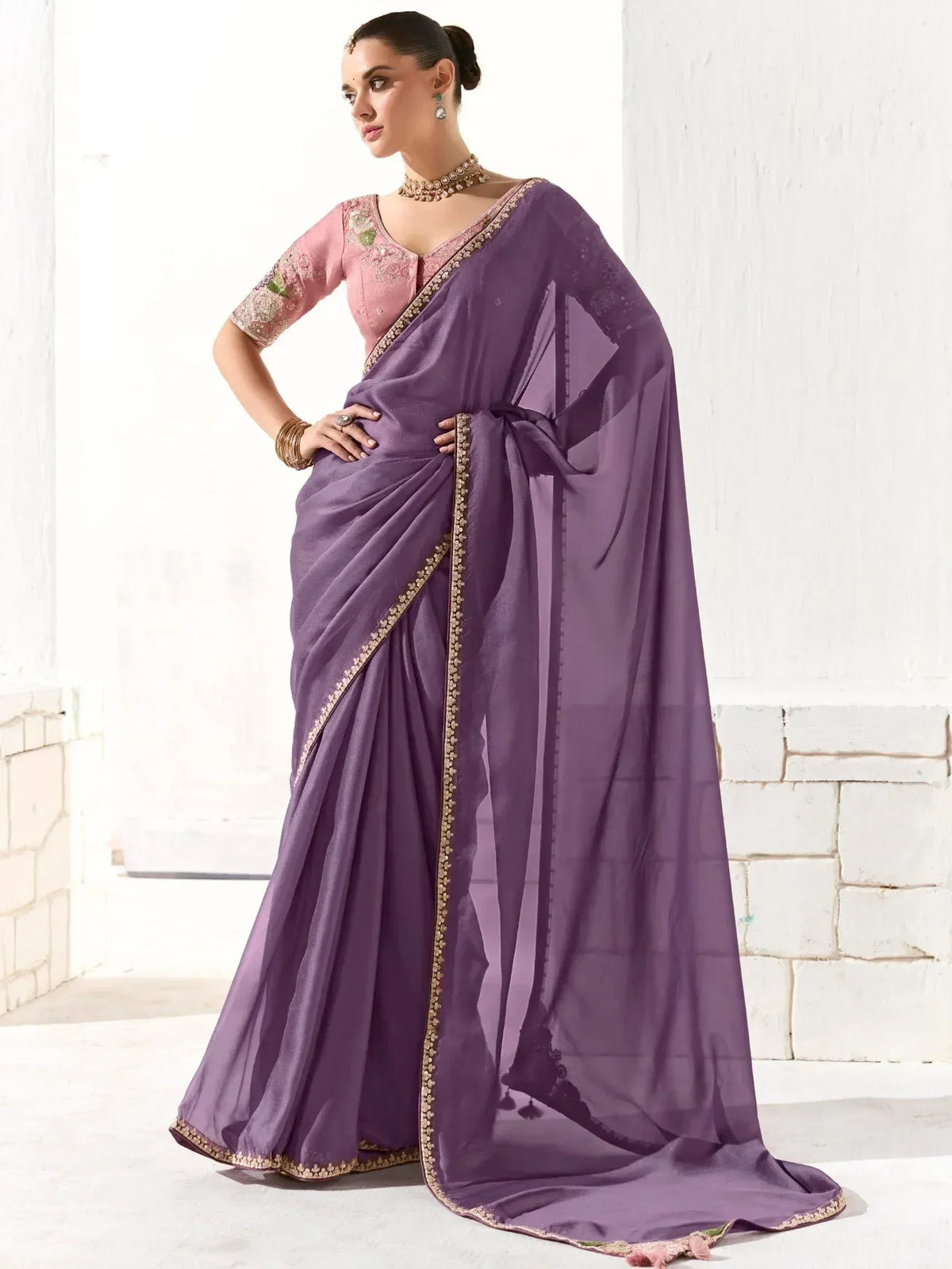 Elegant purple saree with gold border and pink embroidered blouse, perfect for Indian ethnic occasions.