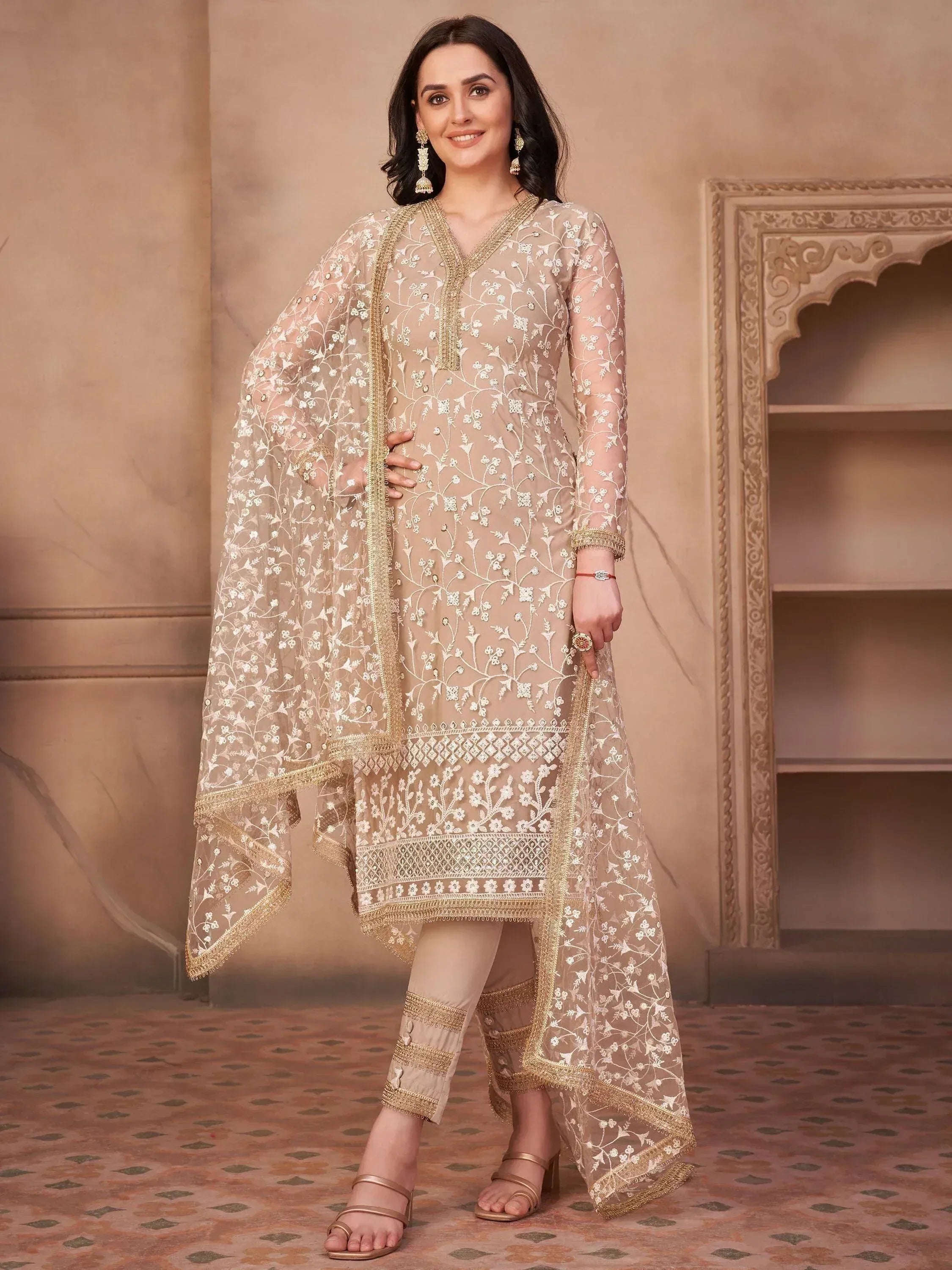 Woman wearing beige embroidered salwar kameez suit with dupatta, ethnic Indian outfit