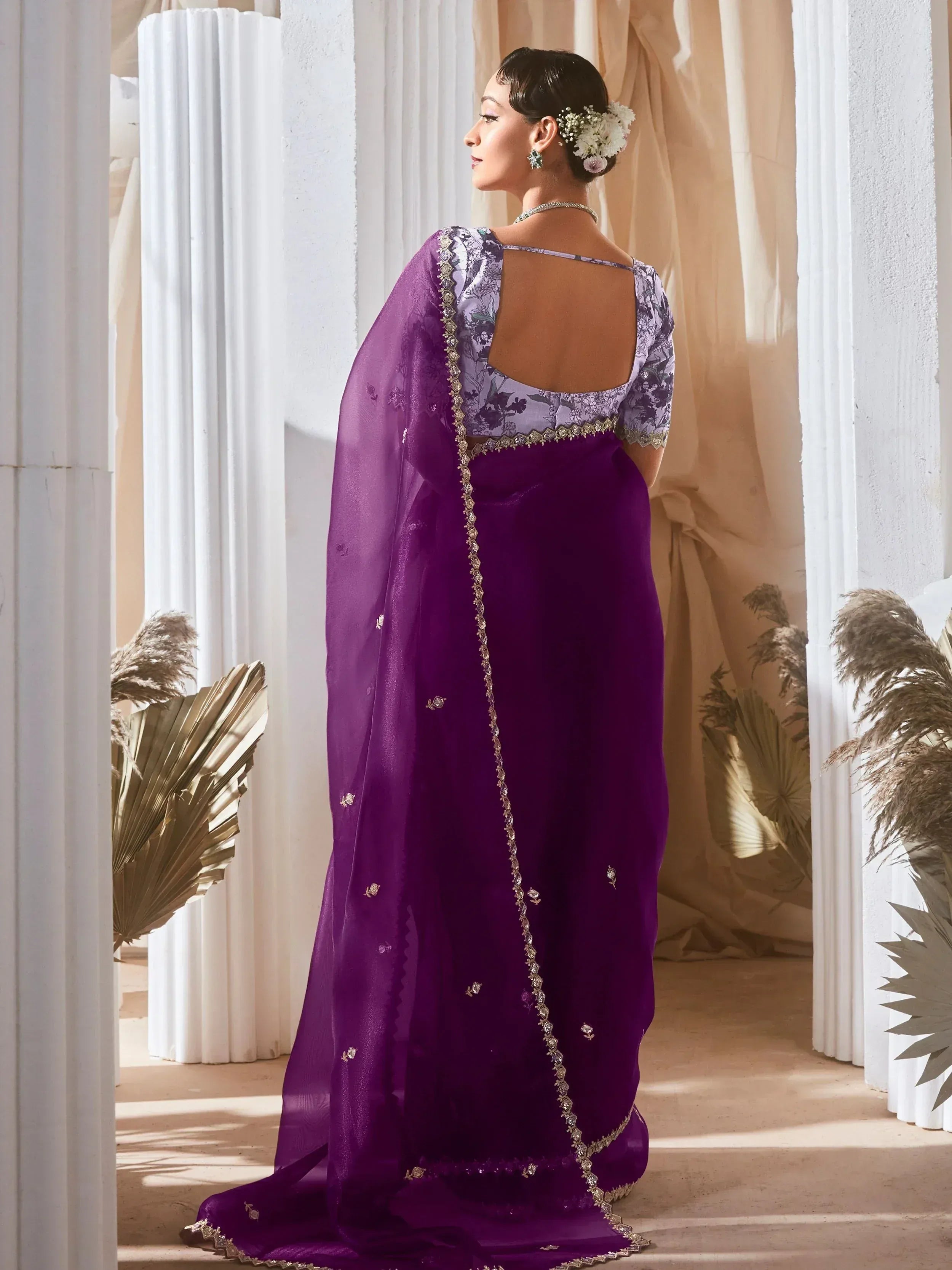Elegant purple saree with floral blouse and gold embroidery, perfect for Indian ethnic wear