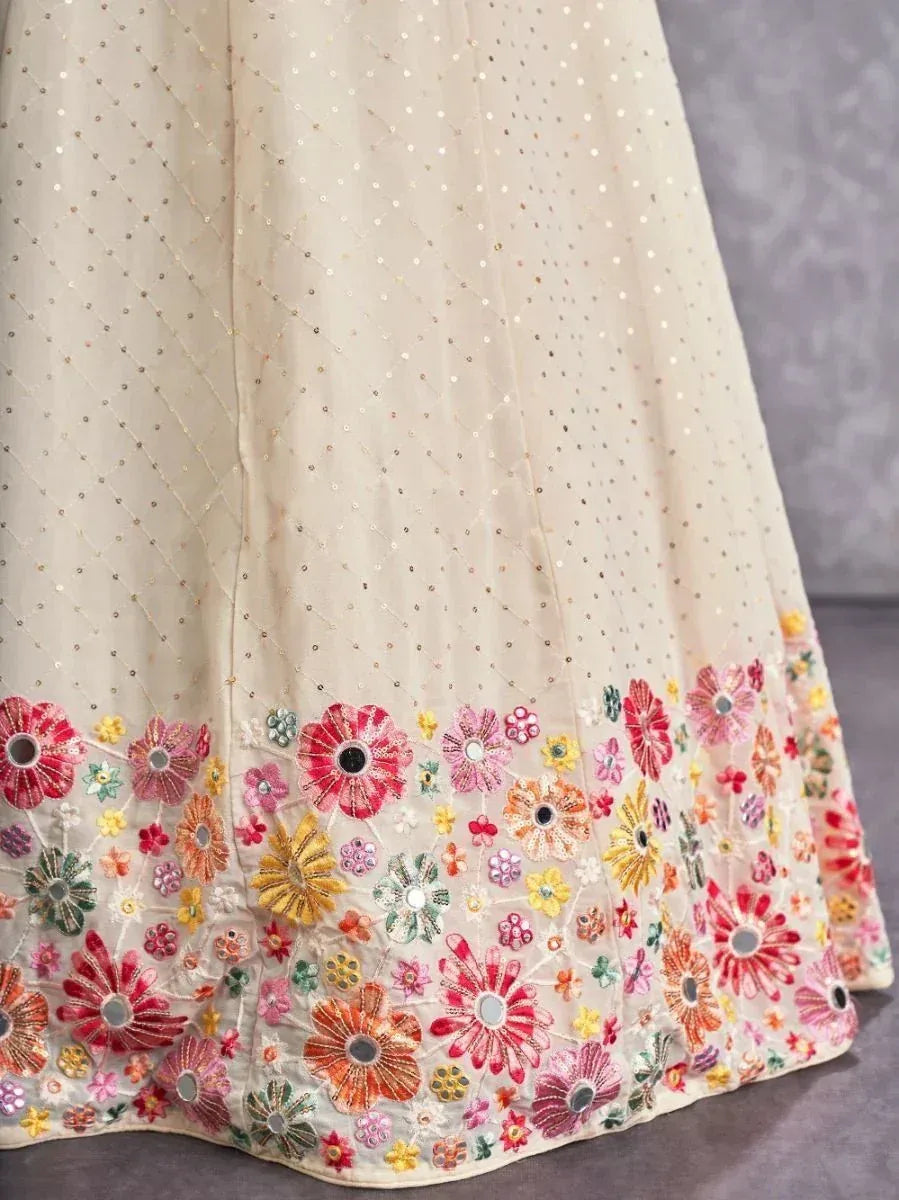 Cream lehenga with colorful floral embroidery and sequin detailing, perfect for Indian ethnic wear