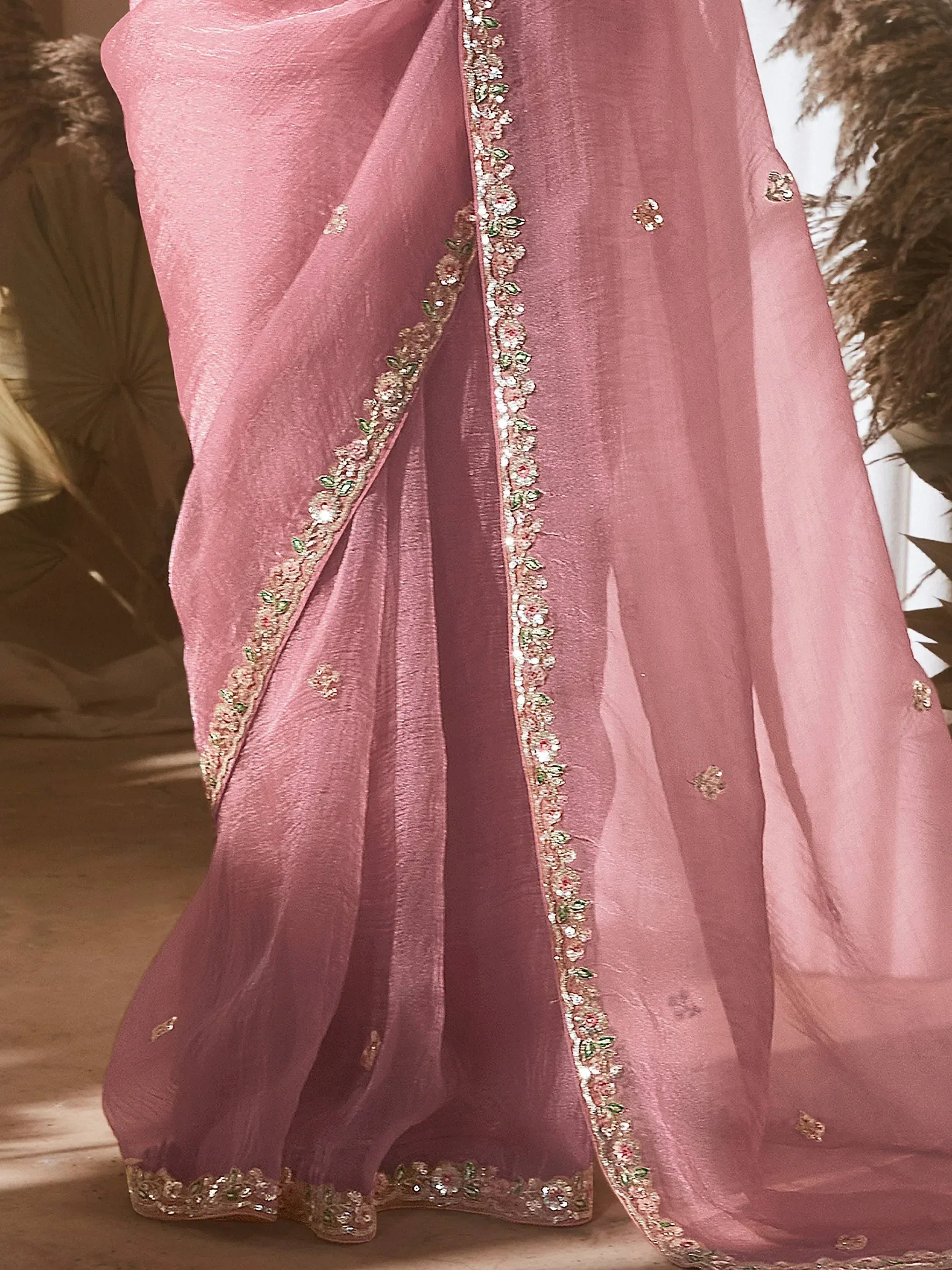 Pink ethnic saree with floral embroidery and sequin border, ideal for Indian occasions