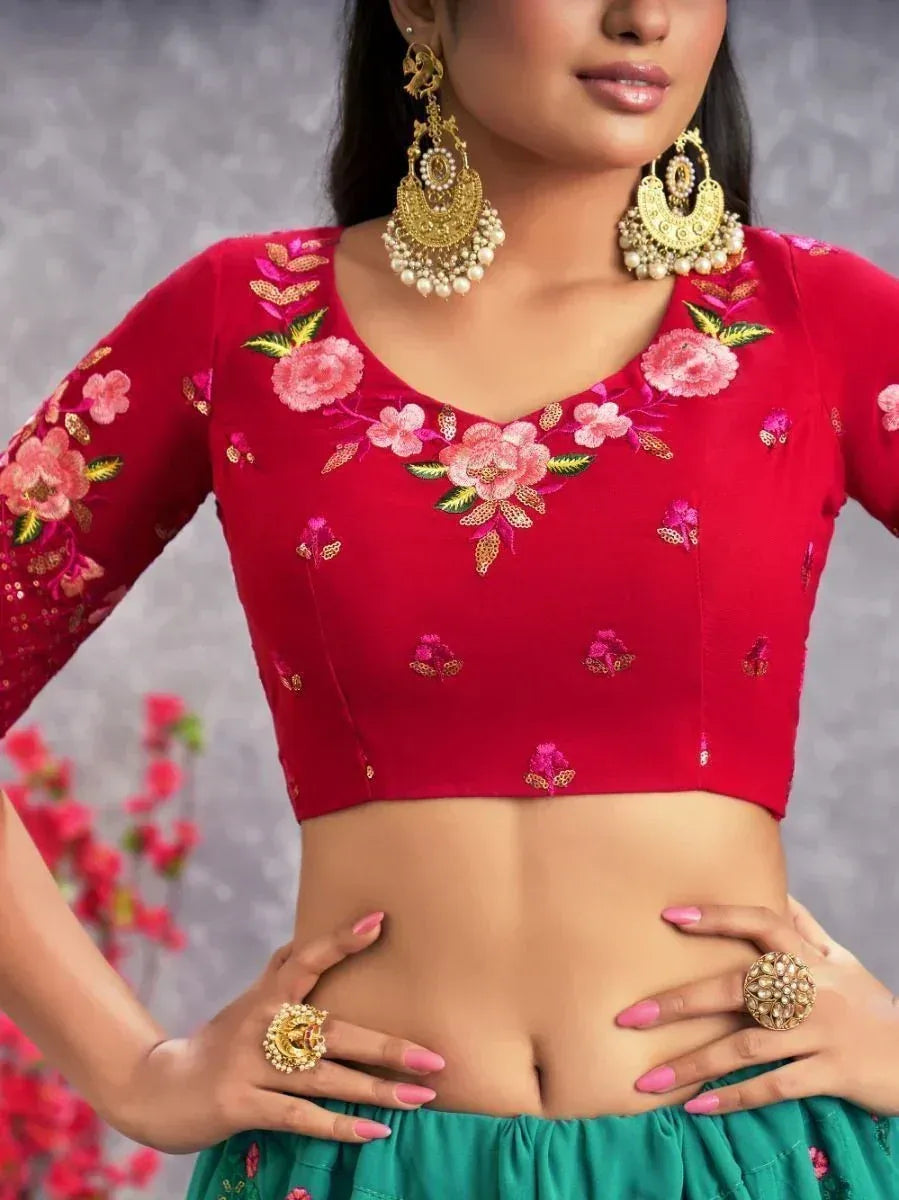 Red floral embroidered blouse with gold jewelry, perfect for Indian ethnic wear