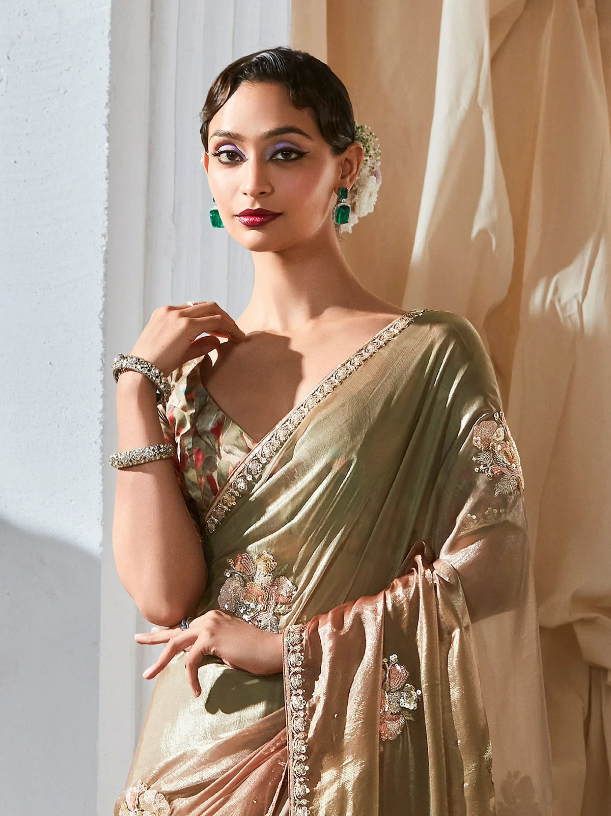Elegant woman in gold embroidered saree with floral blouse, perfect for Indian ethnic wear occasions.