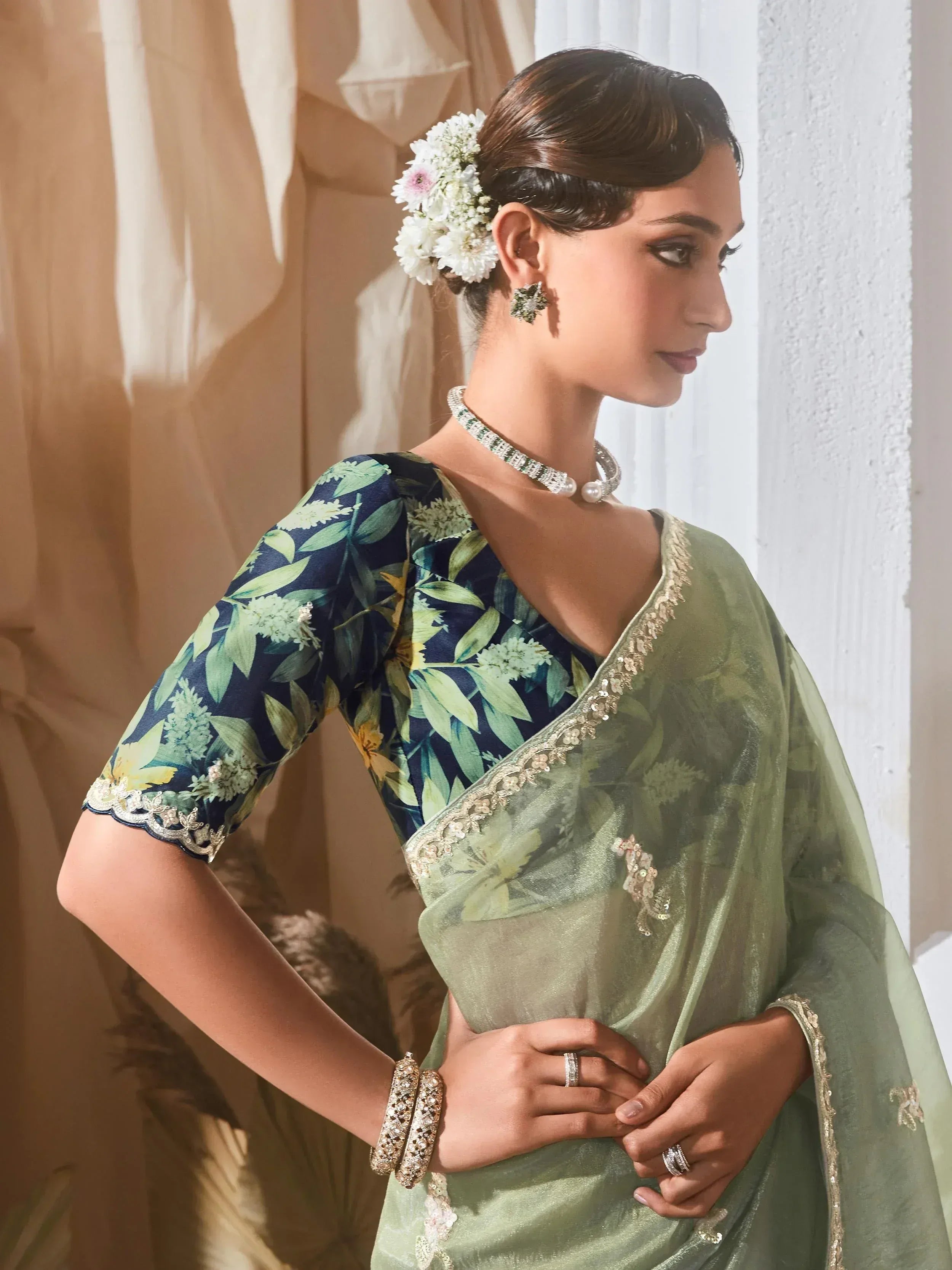 Elegant green saree with floral blouse, perfect for Indian ethnic wear occasions