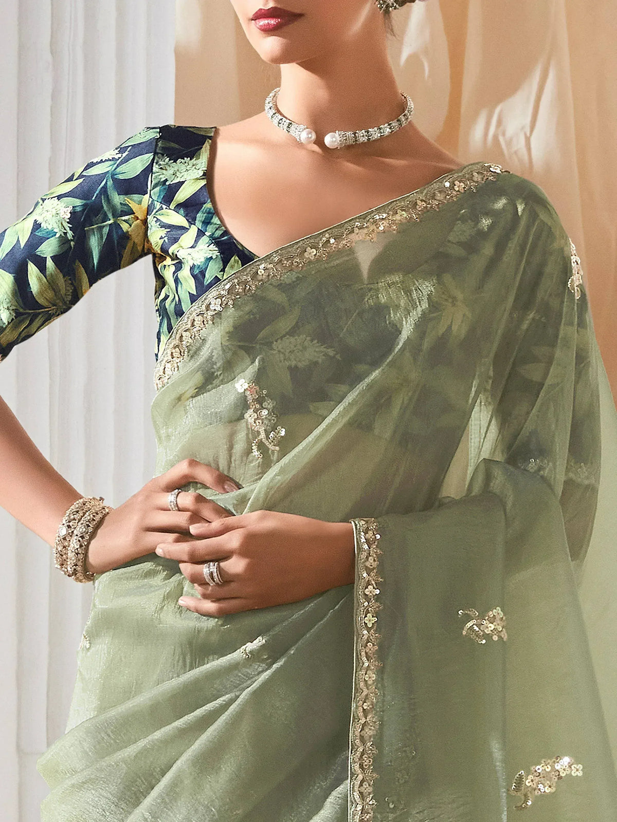 Elegant green saree with floral blouse and gold embroidery, perfect for Indian ethnic occasions