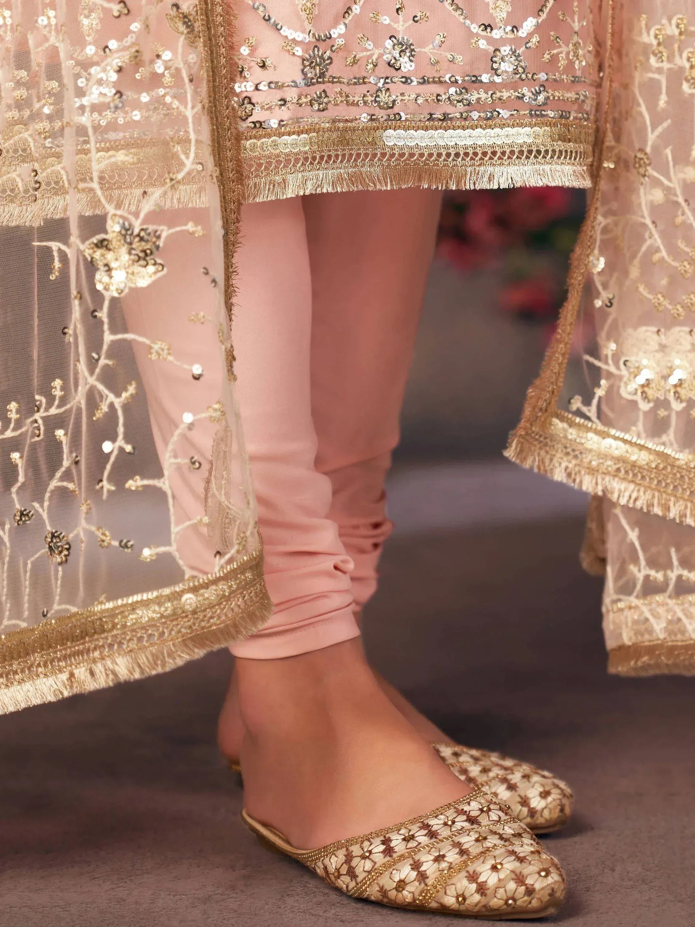 Pink ethnic salwar kameez with gold sequin embroidery and matching floral juttis for festive wear