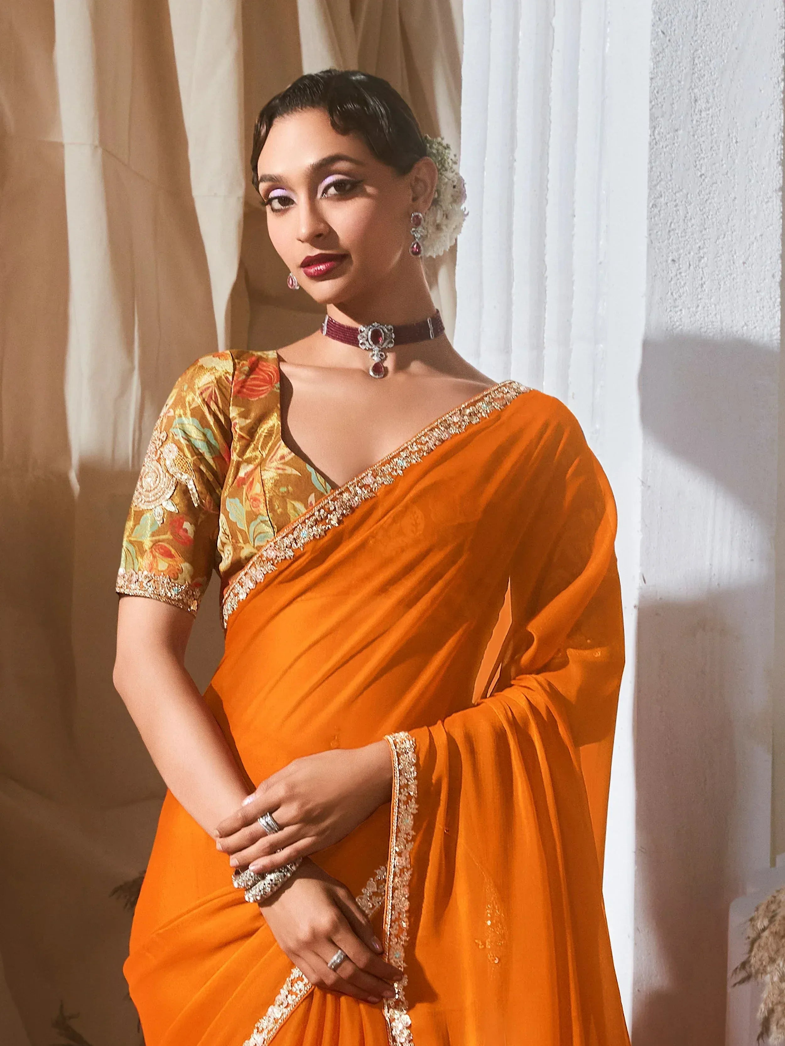 Orange velvet saree with floral blouse, perfect for Indian ethnic wear events