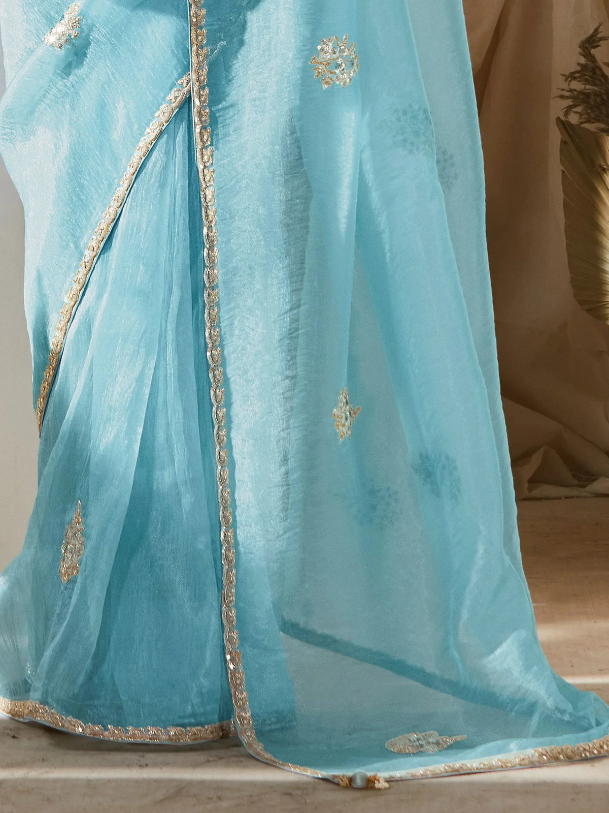 Light blue ethnic gown with gold embroidery and sequin detailing, perfect for festive occasions.