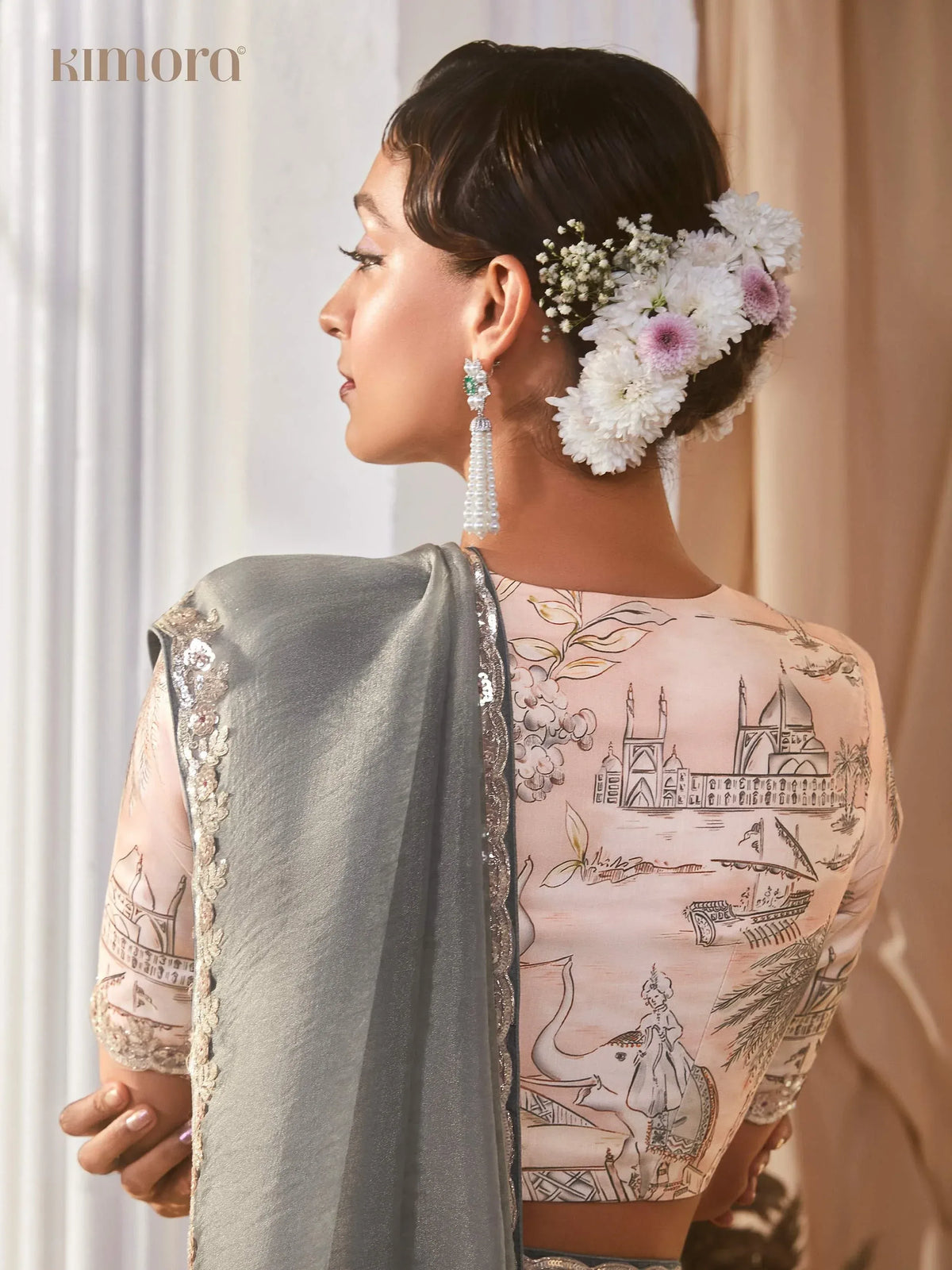 Elegant ethnic wear with architectural print, floral hair accessory, and pearl earrings for Indian occasions