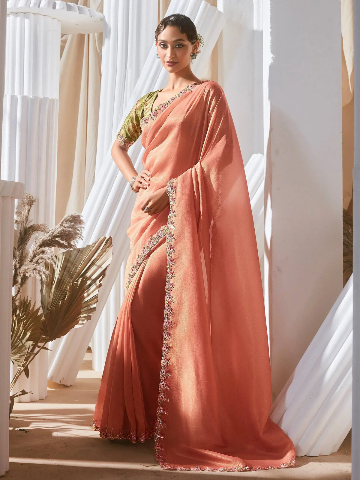 Elegant peach saree with floral embroidery and green blouse, perfect for Indian ethnic occasions