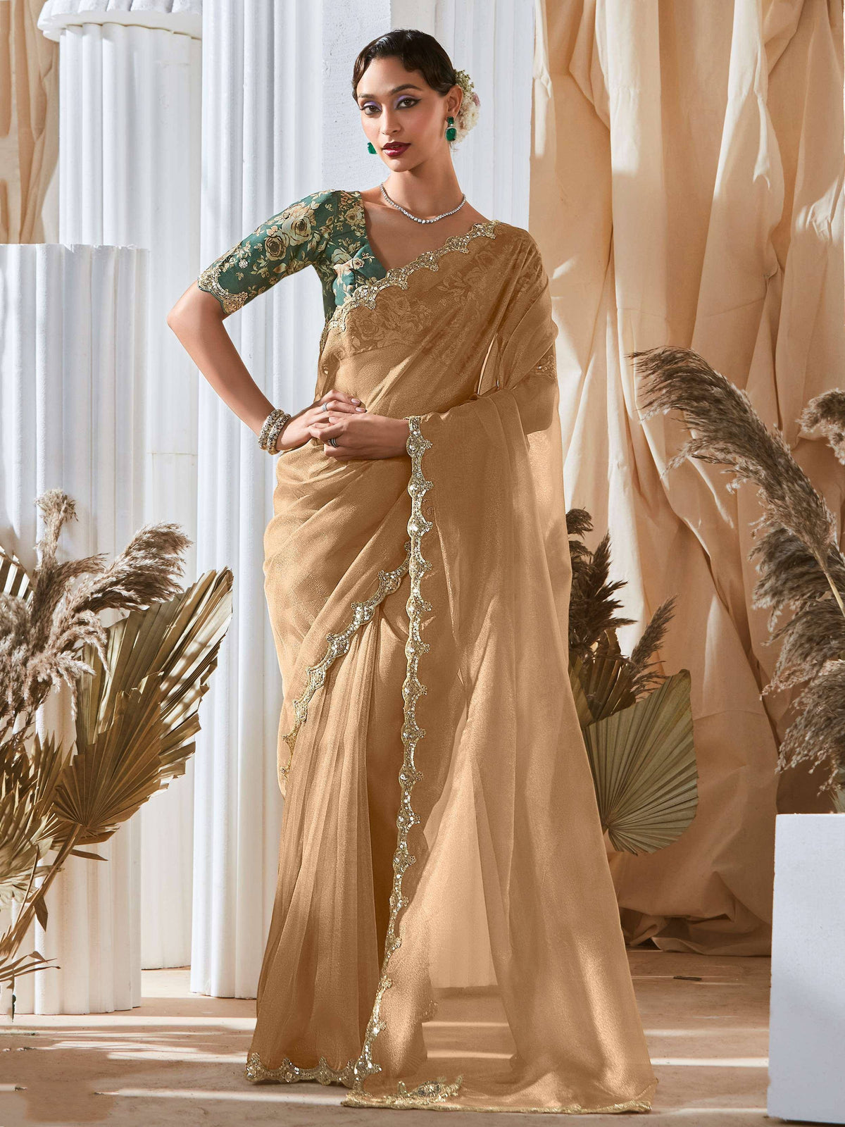 Elegant gold saree with floral green blouse, perfect for Indian ethnic wear occasions