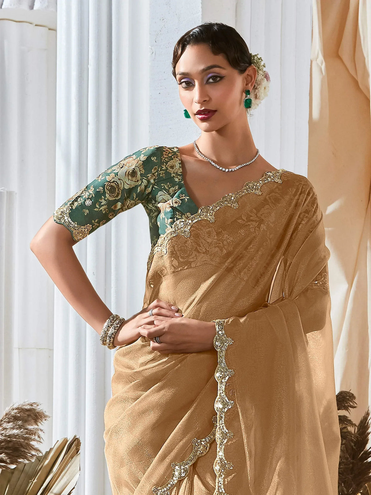Elegant gold saree with green floral blouse, perfect for Indian ethnic occasions and weddings.