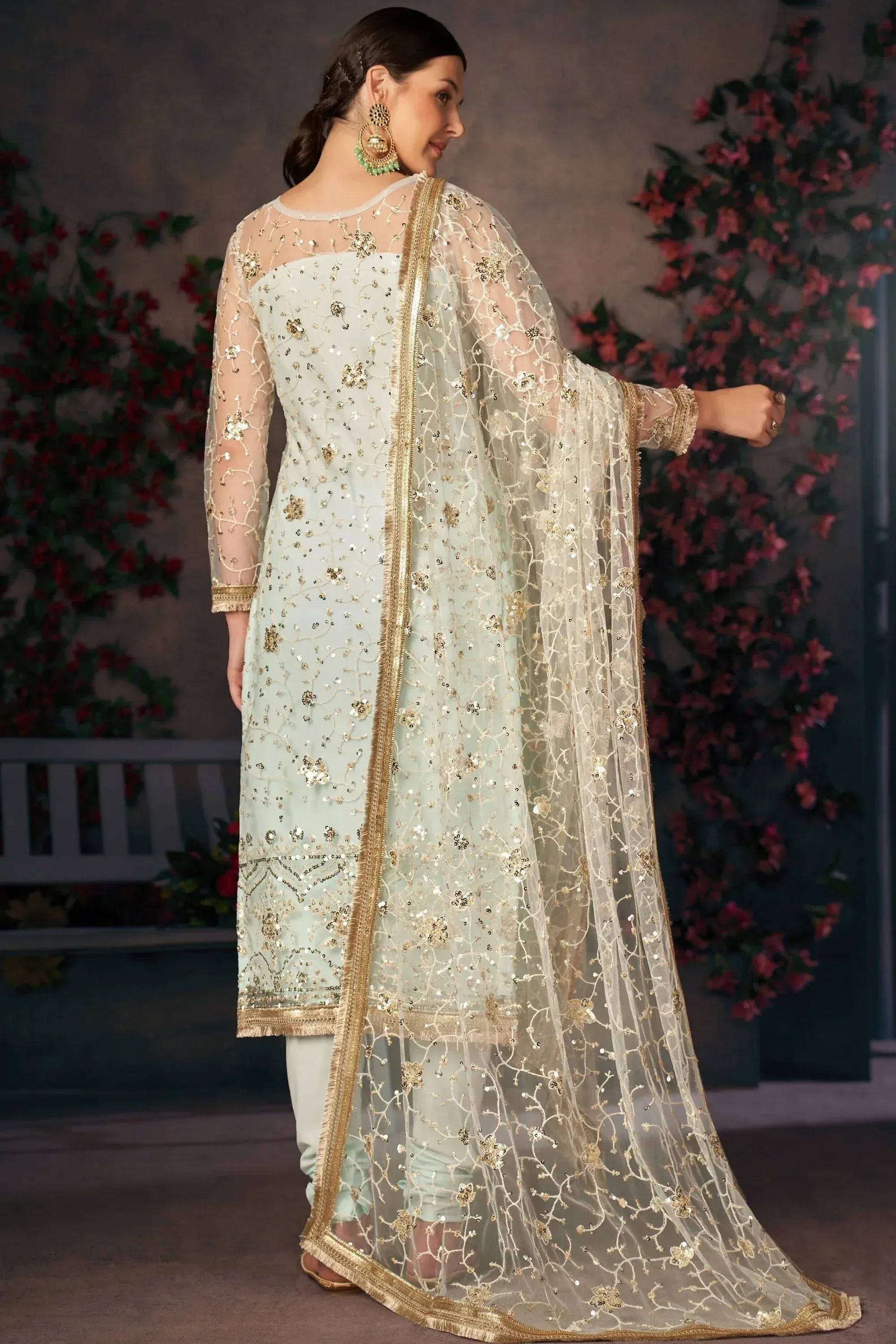 Elegant mint green salwar kameez with gold embroidery and sheer dupatta, perfect for Indian ethnic occasions.
