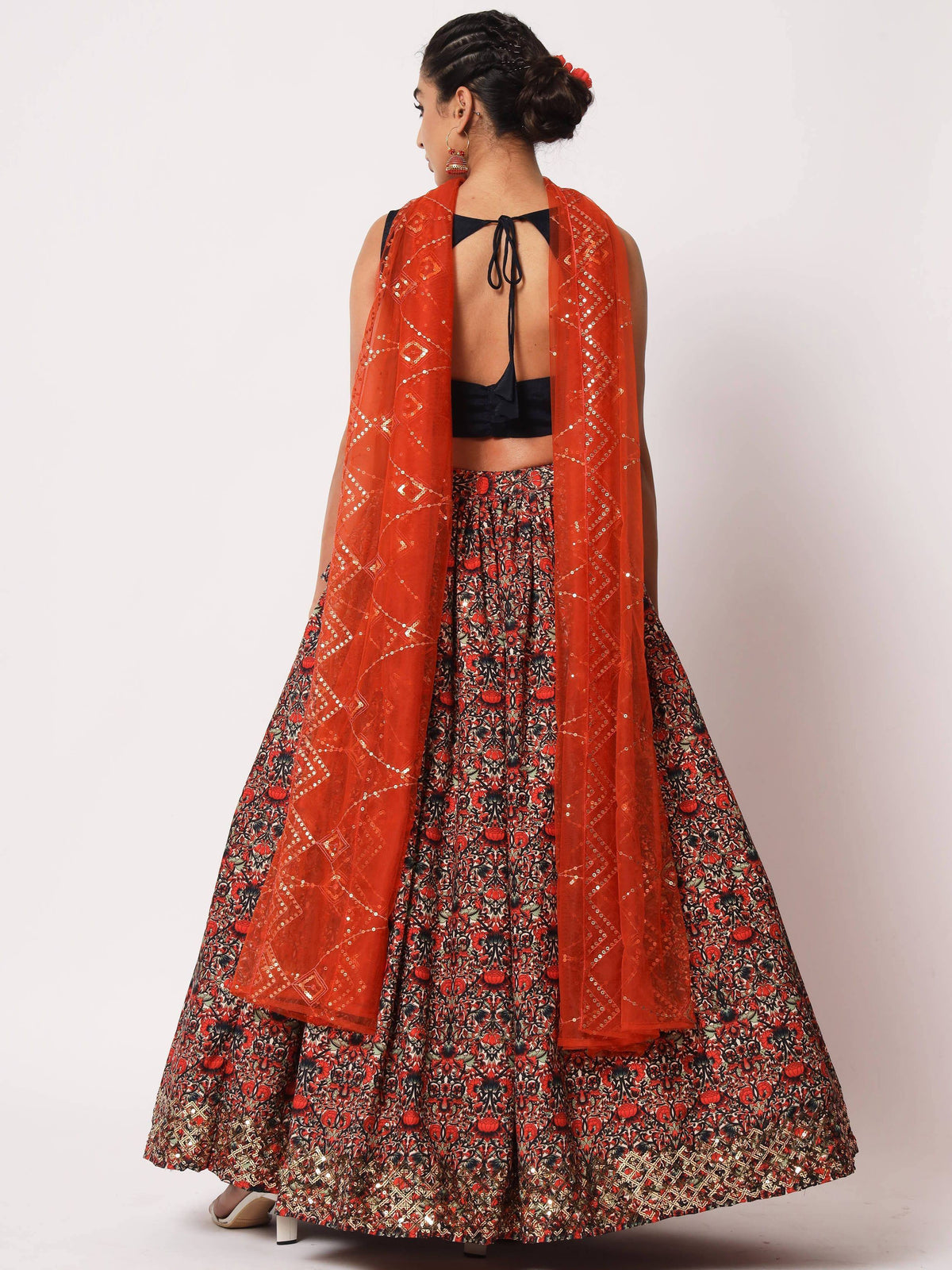 Floral print lehenga choli with orange sequin dupatta, back view