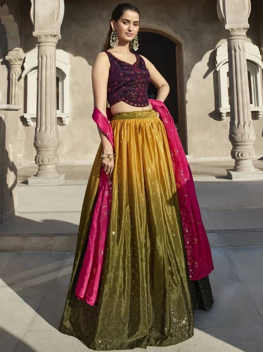 Elegant purple floral crop top with golden lehenga and pink dupatta, perfect for Indian ethnic occasions