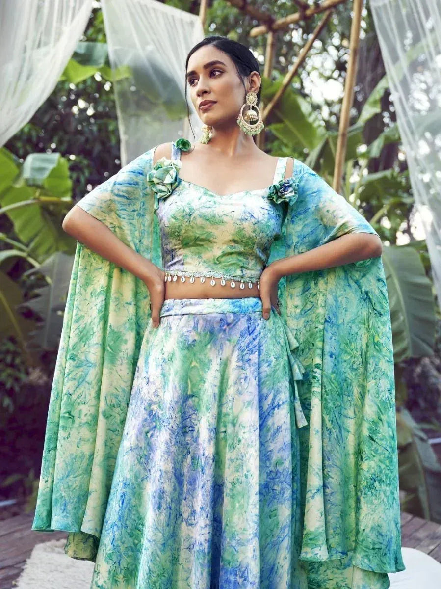 Green and blue tie-dye lehenga choli with floral embellishments, perfect for ethnic occasions