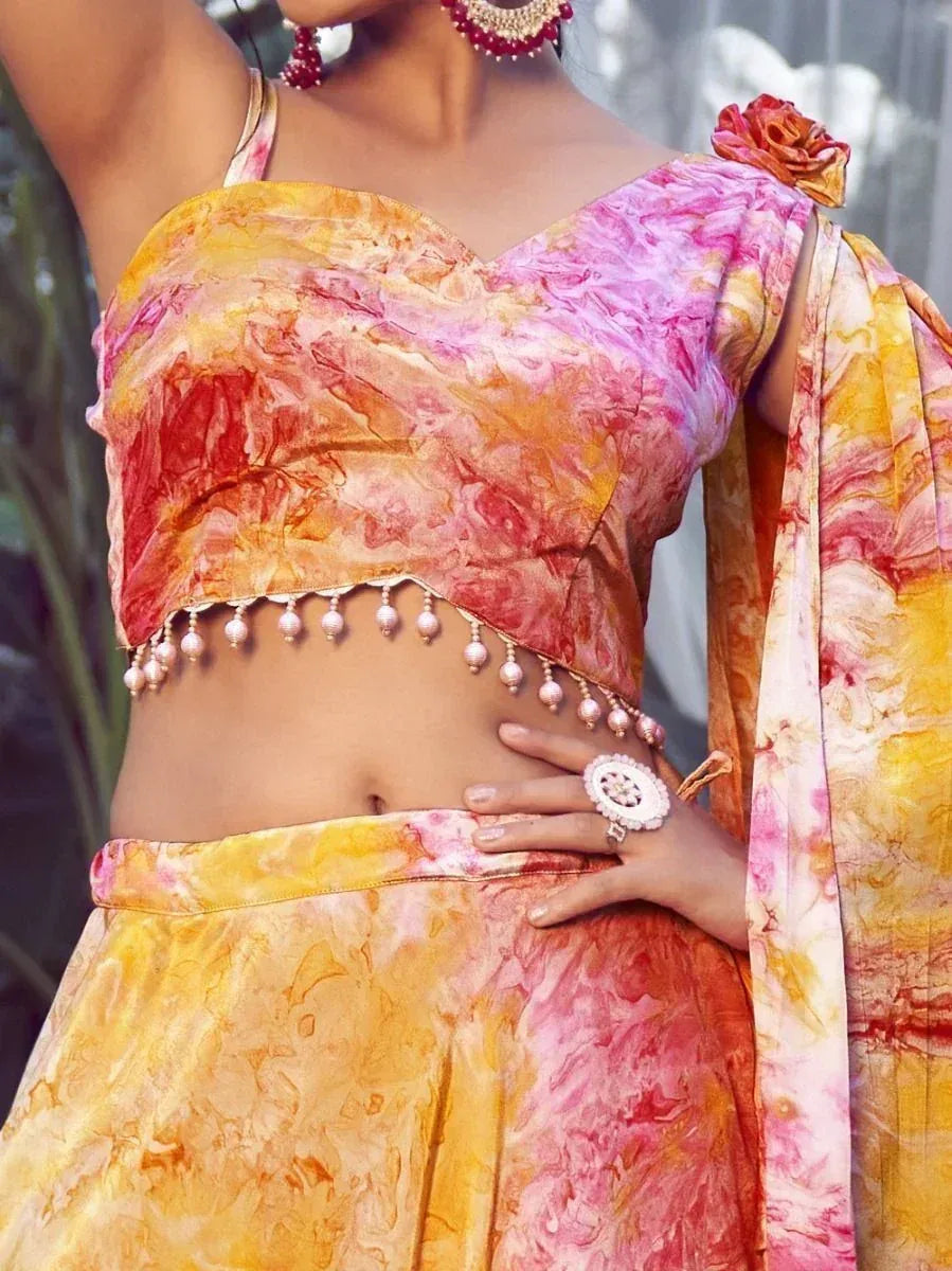 Vibrant tie-dye lehenga choli with pearl embellishments, perfect for Indian ethnic wear