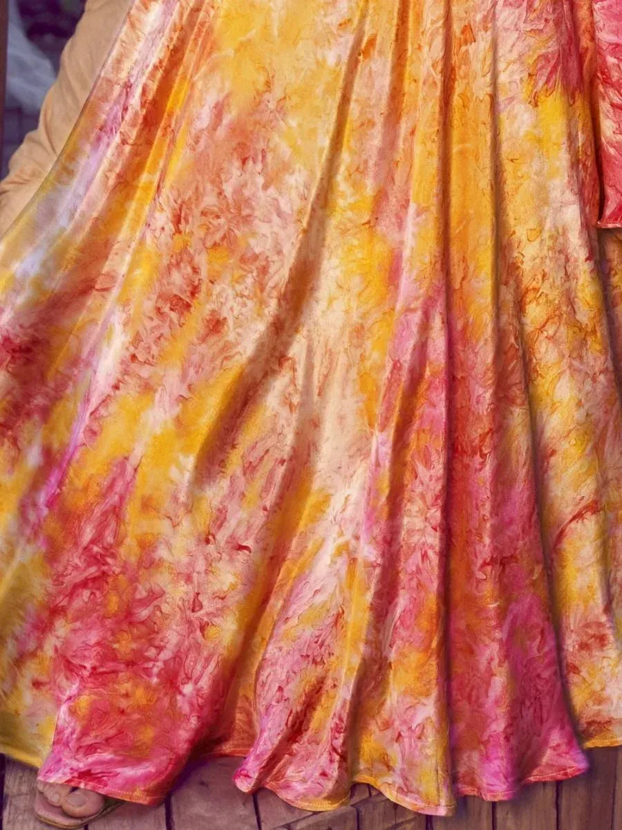 Vibrant tie-dye ethnic gown in yellow pink hues, flowing pleated skirt for festive occasions