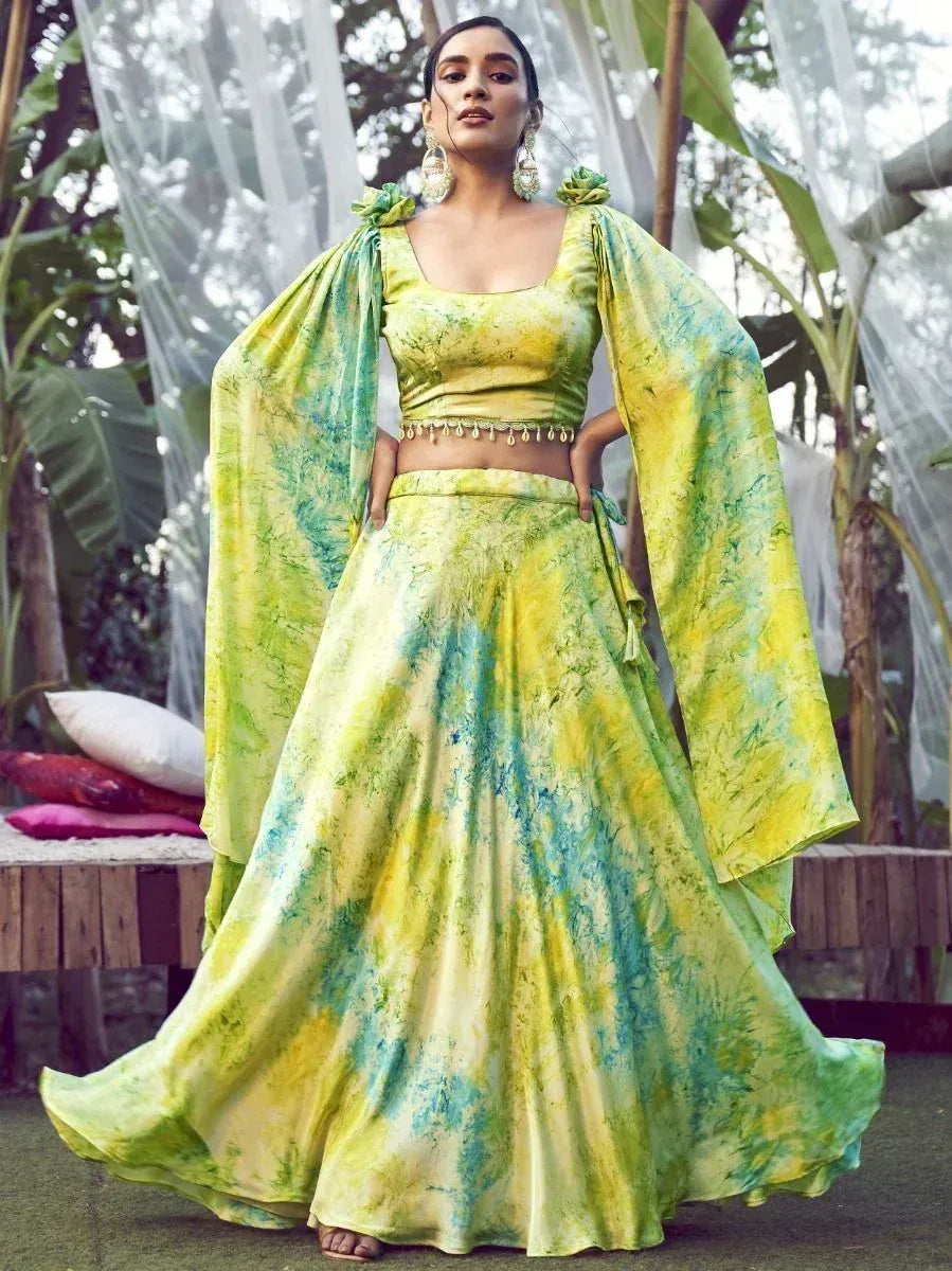 Vibrant yellow-green tie-dye lehenga choli with cape sleeves, perfect for ethnic occasions