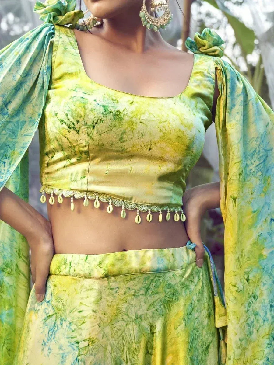 Green and yellow tie-dye lehenga choli with embellished border and cape sleeves
