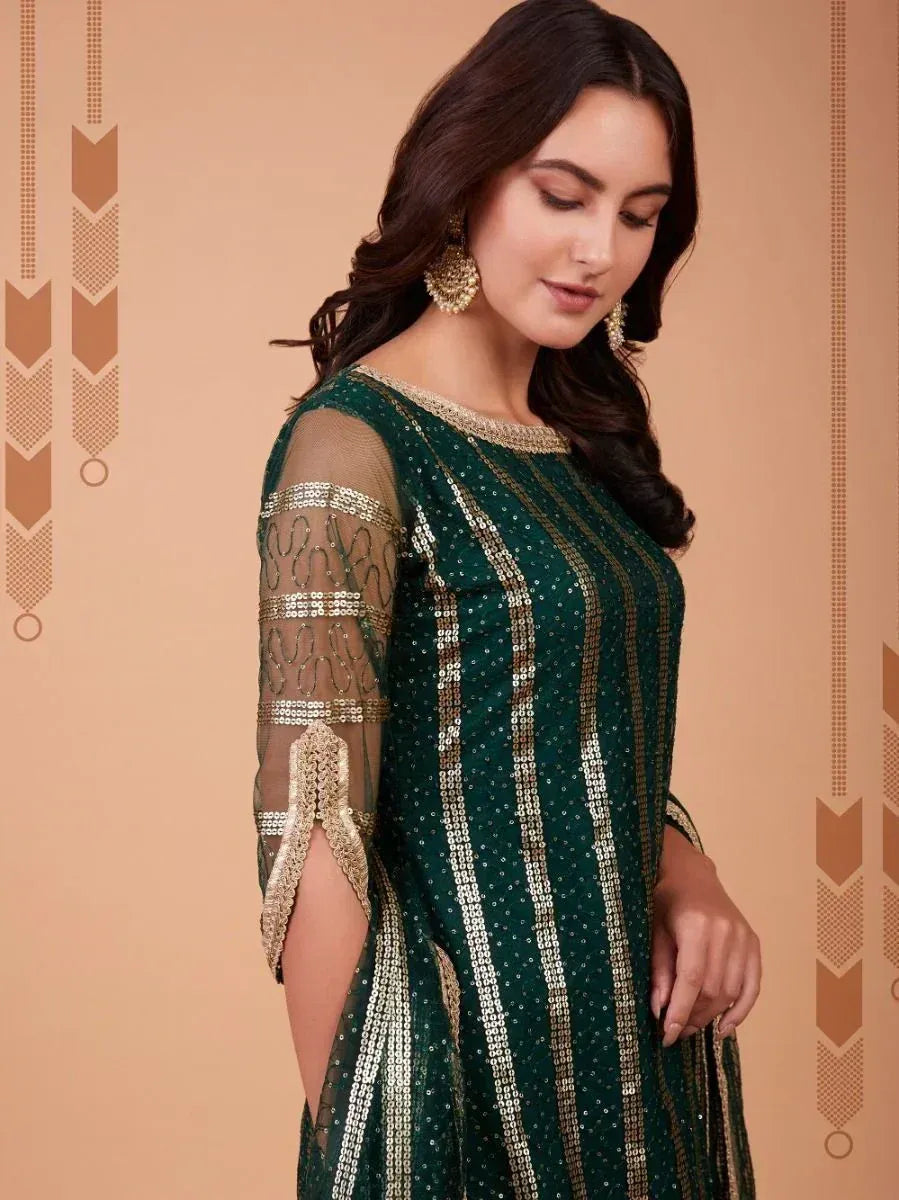 Emerald green ethnic gown with gold sequin stripes and sheer sleeves, perfect for Indian festive occasions.